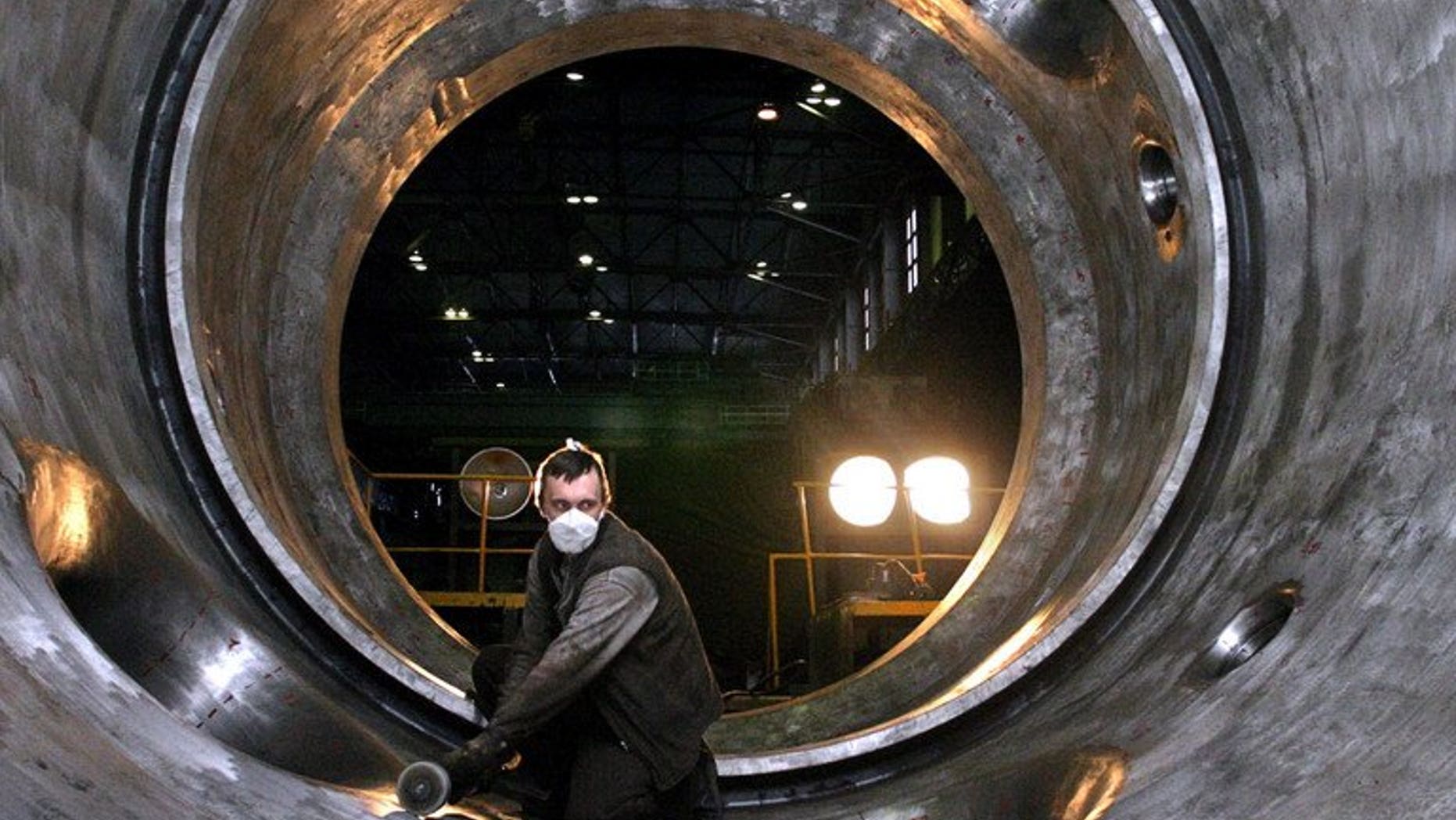 This file photo shows an employee of the Izhorsky engineering plant in St.Petersburg polishing the interior of a 1,000-megawatt nuclear power reactor for Indian nuclear power plant in Kudankulam, on November 18, 2004. The Russian-built Kudankulam plant is India's biggest nuclear power project and is designed to help meet a surging demand for electricity in Asia's third-largest economy
