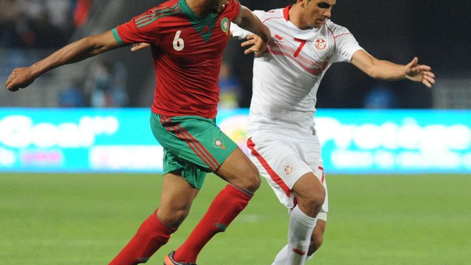 Morocco's Benjelloun Abdessamad (left) vies for the ball with Tunisia's Mhirsi Driss during the African Nations Championship qualifying match on July 13, 2013. Holders Tunisia were eliminated in the first qualifying round after drawing 0-0.