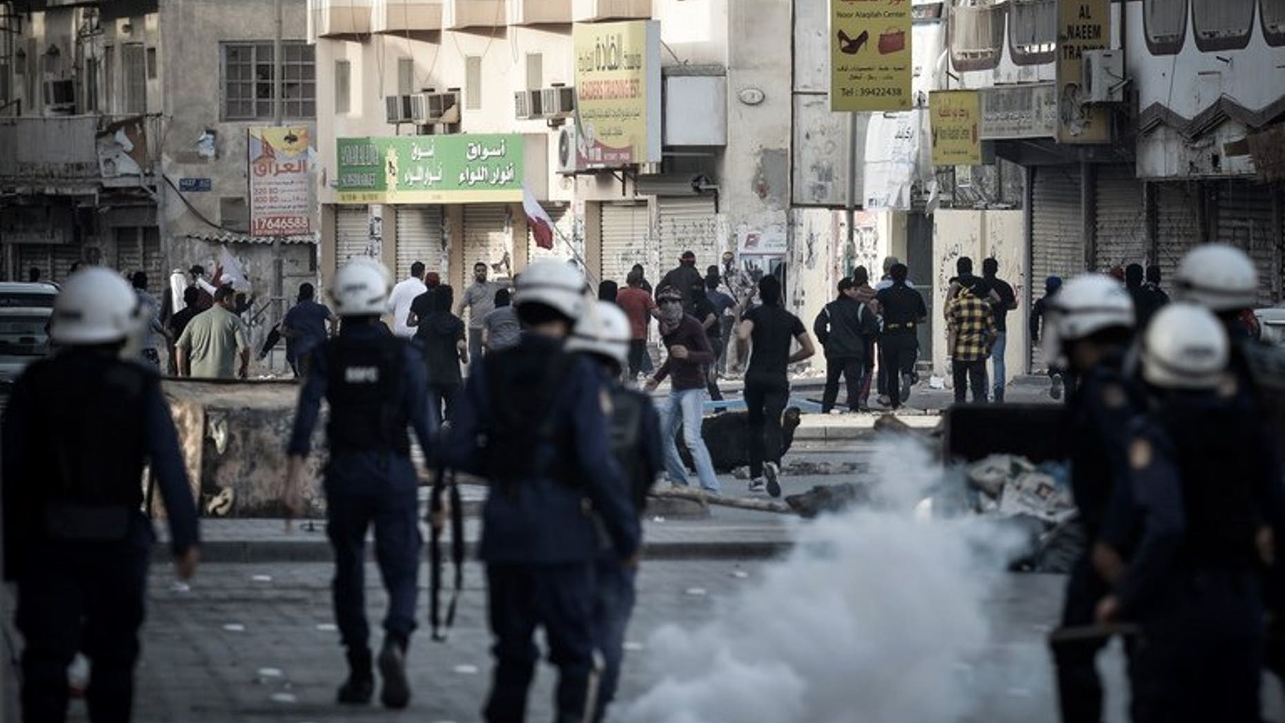 Bahraini riot police disperse protesters during a demonstration in Daih, on February 22, 2013. A home-made bomb has wounded four Bahraini policemen outside a Shiite village, the interior ministry said in the latest unrest to rock the Sunni-ruled Shiite-majority Gulf state.