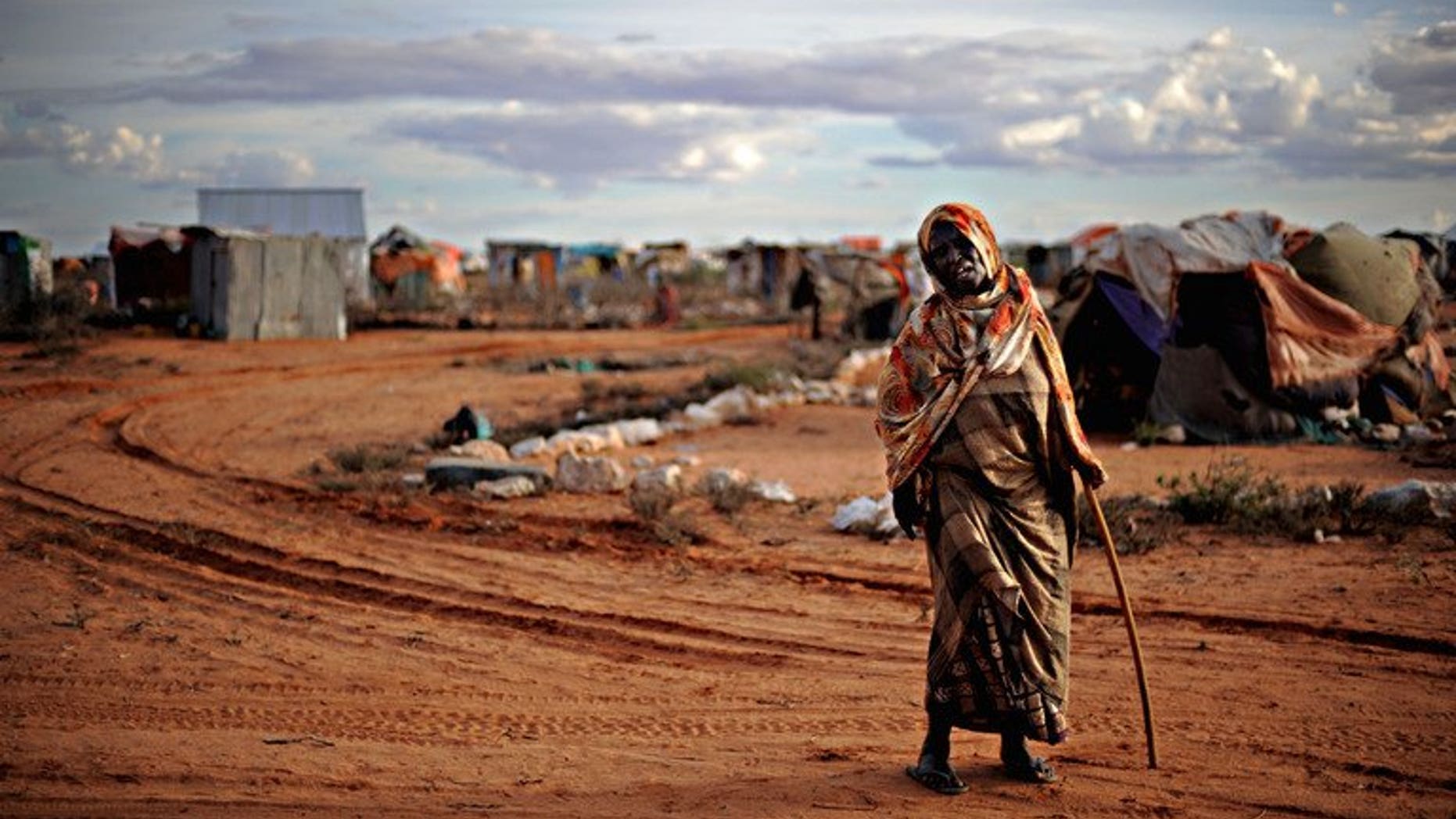 An elderly woman displaced by violence walks in a refugee camp in the northern breakaway state of Puntland on October 17, 2009. Somalia's semi-autonomous northern region has suspended long-awaited local elections, its government said, saying the risk of violence was too great to hold them.