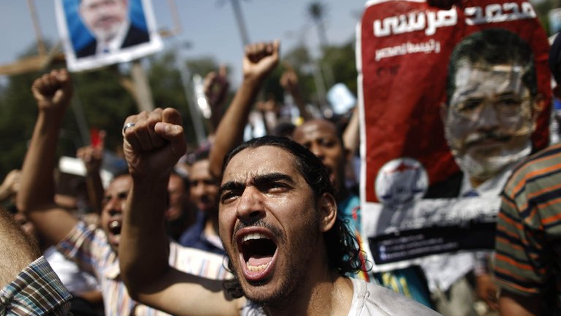 An Egyptian supporter of the Muslim Brotherhood shouts slogans during a protest near Cairo University on July 5, 2013. Egypt's public prosecutor on Sunday ordered the freezing of assets belonging to 14 top Islamists as part of an investigation into deadly violence, according to judicial sources.