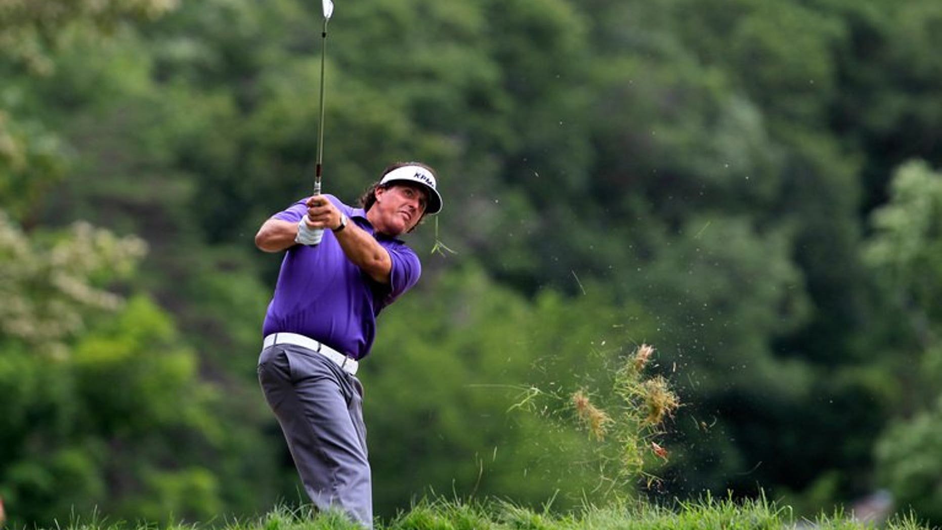 Phil Mickelson watches his second shot on the 6th hole during round two of the Greenbrier Classic at the Old White TPC on July 5, 2013 in White Sulphur Springs, West Virginia. Mickelson heads to the British Open in the best form possible after ending a 20-year European winless drought with a play-off victory in the Scottish Open on Sunday.