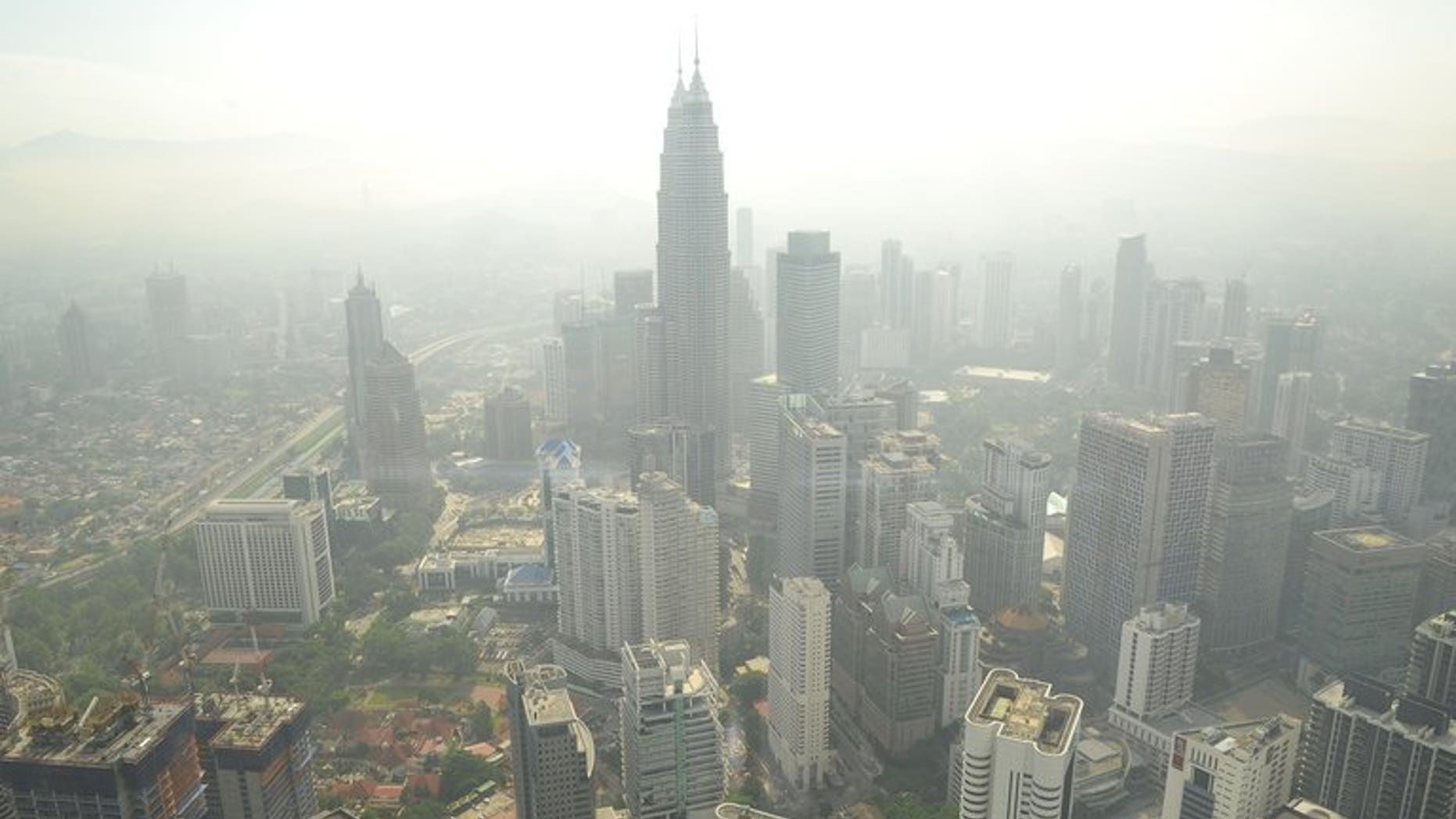 Kuala Lumpur's skyline is seen covered by haze on June 27, 2013. Southeast Asian nations gathering to discuss the annual shroud of hazardous smog that blights the region are unlikely to find any immediate solutions, despite a meeting to address the issue being brought forward by a month to Monday.