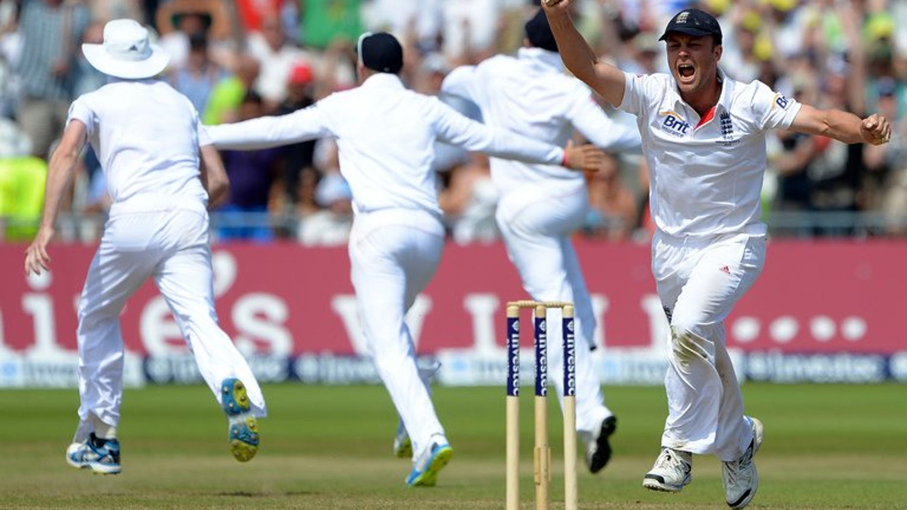 England's Jonathan Trott (R) celebrates victory in the first Ashes Test on July 14, 2014. Britain's newspapers revelled in England's dramatic win, lavishing praise on matchwinner James Anderson, whose four-wicket haul Sunday brought his total for the match to 10.