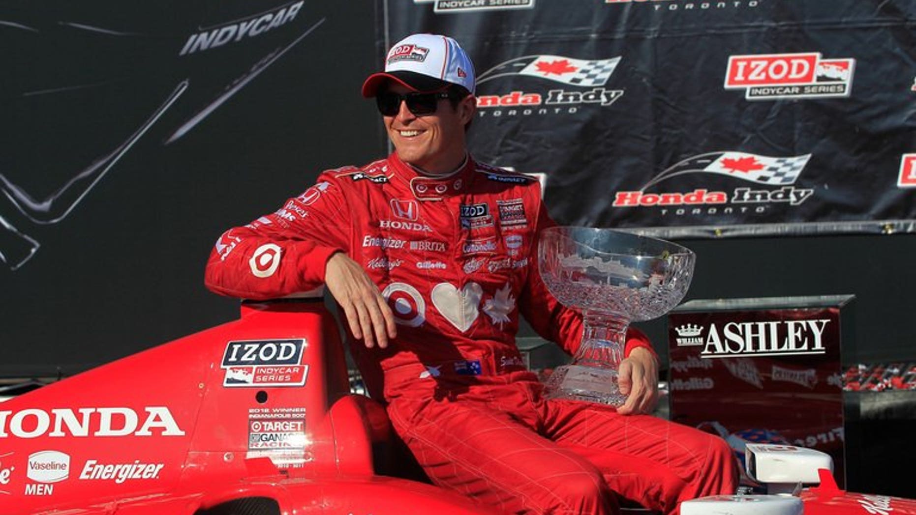 Scott Dixon poses with the trophy on July 14, 2013 after dominating Toronto's IndyCar street circuit. Dixon, who won last weekend's race in Pocono, captured his third victory in a row and 32nd career title.