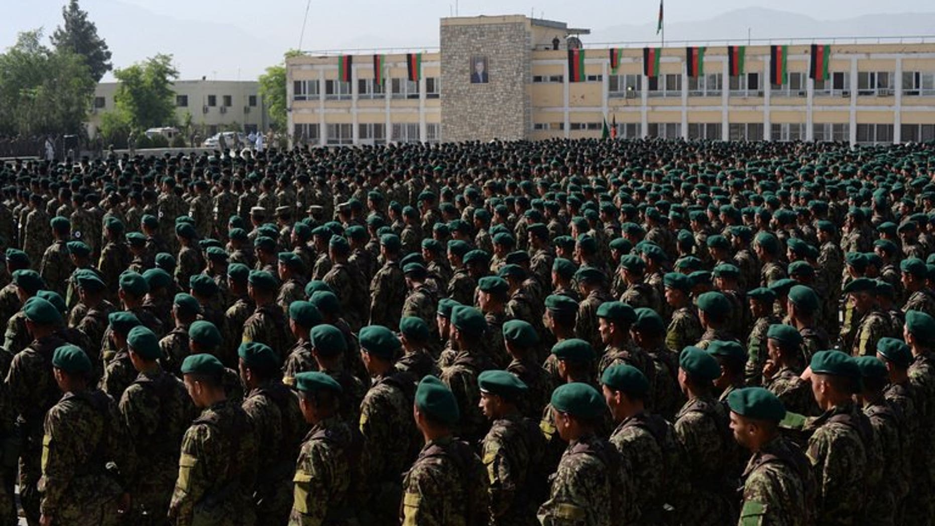 This file photo shows newly graduated Afghan National Army soldiers attending their graduation ceremony in Kabul, on May 23, 2013. An Afghan soldier held on suspicion of killing a NATO soldier from Slovakia has escaped from prison on a heavily guarded military base with the help of a guard, officials said on Monday.