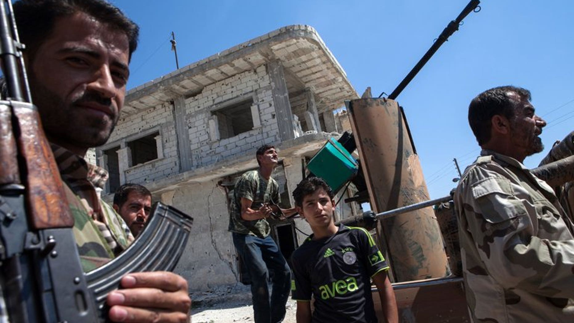 Syrian rebels try to locate a fighter plane in the village of Al-Rami in Idlib on June 22, 2013. Shelling and air raids by Syrian government forces against a string of villages in the northwestern province of Idlib killed at least 29 people, a watchdog said.