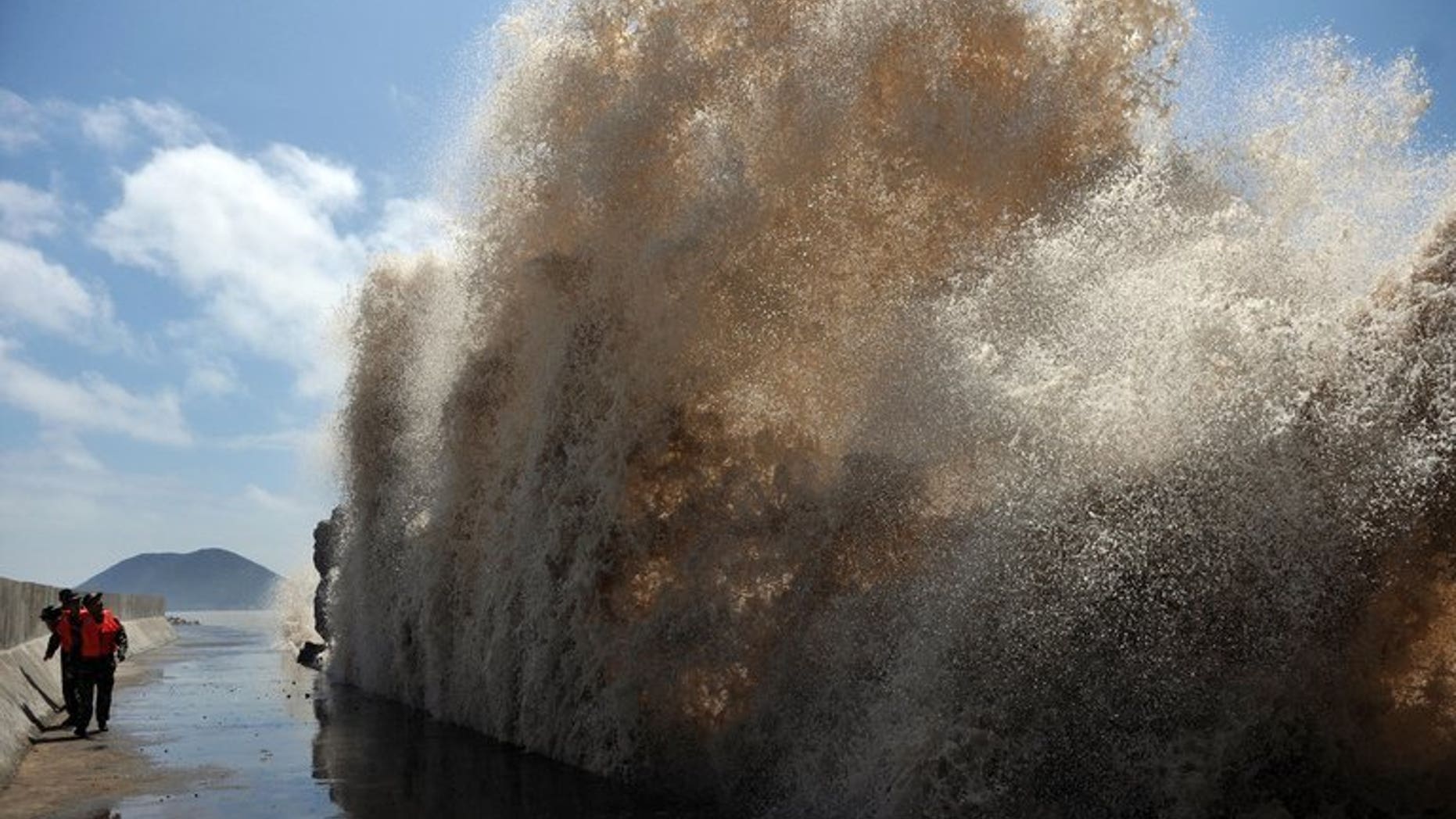 Huge waves surge up against the shoreline of Diaobin fishing port in Wenling, eastern China, on July 12, 2013. At least 295 people have been confirmed dead or missing after rainstorms and Typhoon Soulik hit China, causing floods, landslides and buildings to collapse.