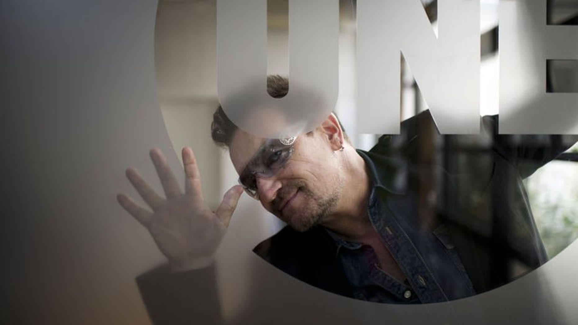 U2 frontman Bono poses on October 19, 2011 at the Paris headquarters of anti-poverty group ONE which he founded. France is to bestow its highest cultural honour on the singer, a government statement said.