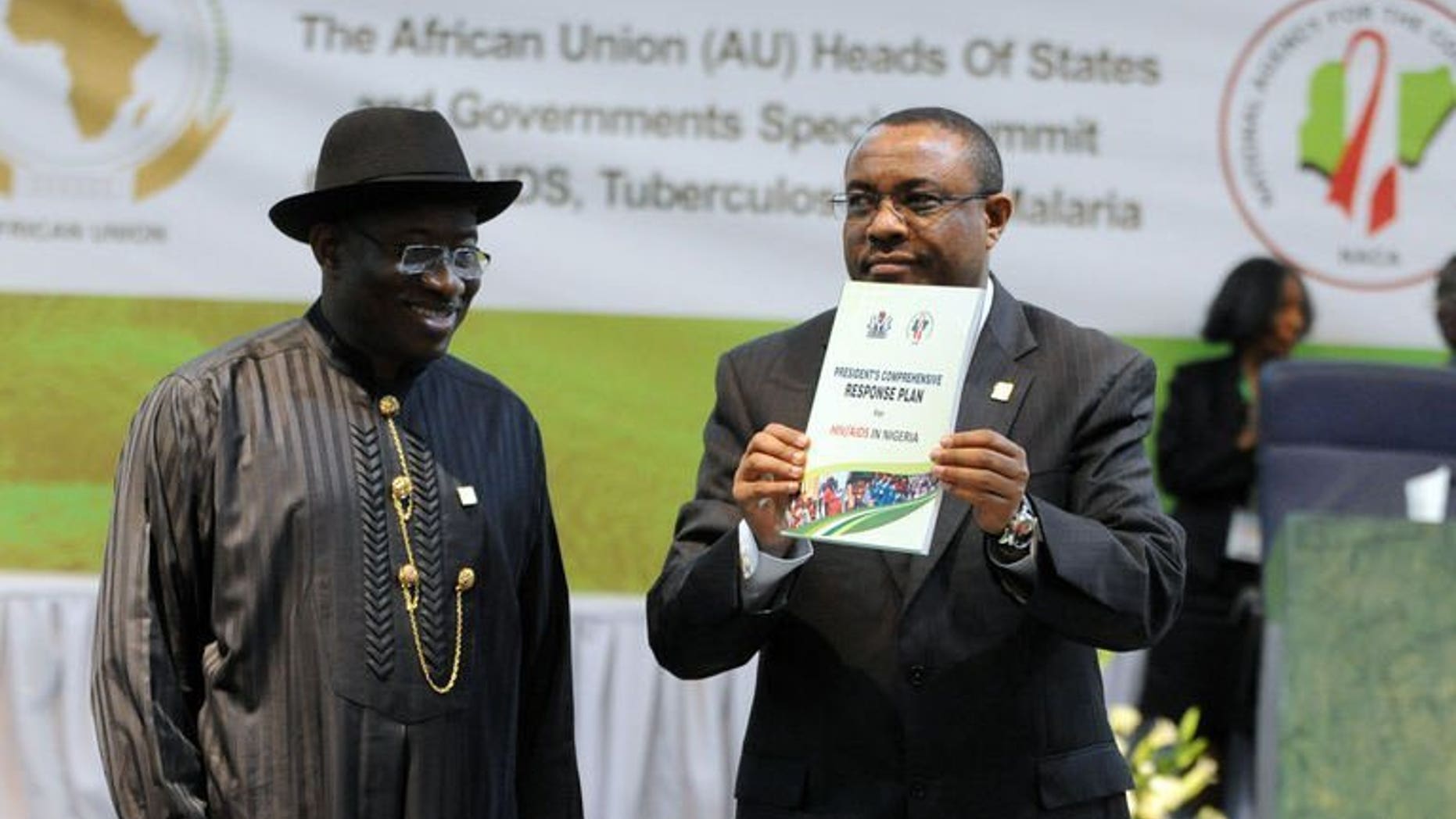 Nigeria's President Goodluck Jonathan looks on as Ethiopian PM Hailemariam Desalegn displays a publication at the opening session of the African Union Summit on health focusing on HIV/AIDS, TB and Malaria in Abuja on July 15, 2013. African leaders called for increased funding Monday to contain HIV/AIDS, TB and malaria as the continental health summit opened in Nigeria's capital.