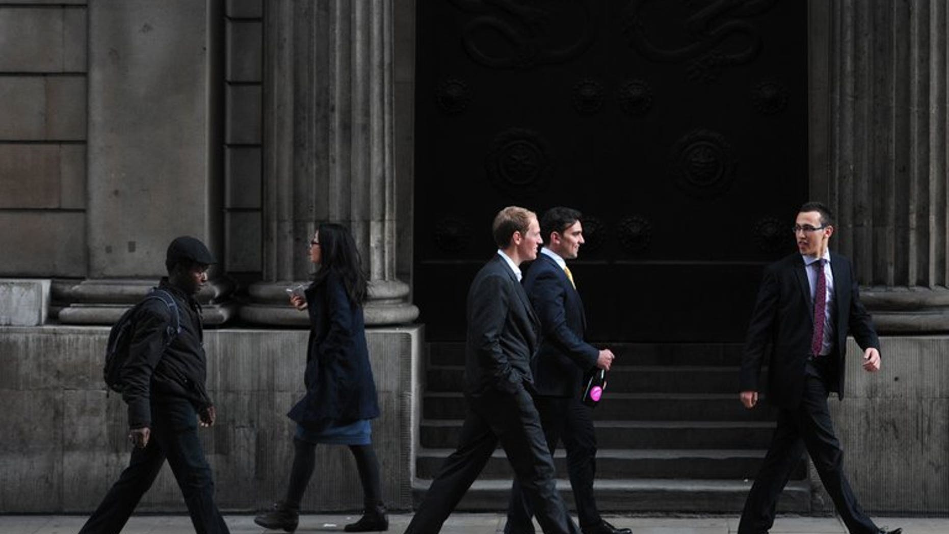 People walk past the Bank of England in the City of London on September 28, 2012. Britain's Serious Fraud Office said Monday that two former brokers have been charged with conspiring to manipulate the Libor interbank lending rate.