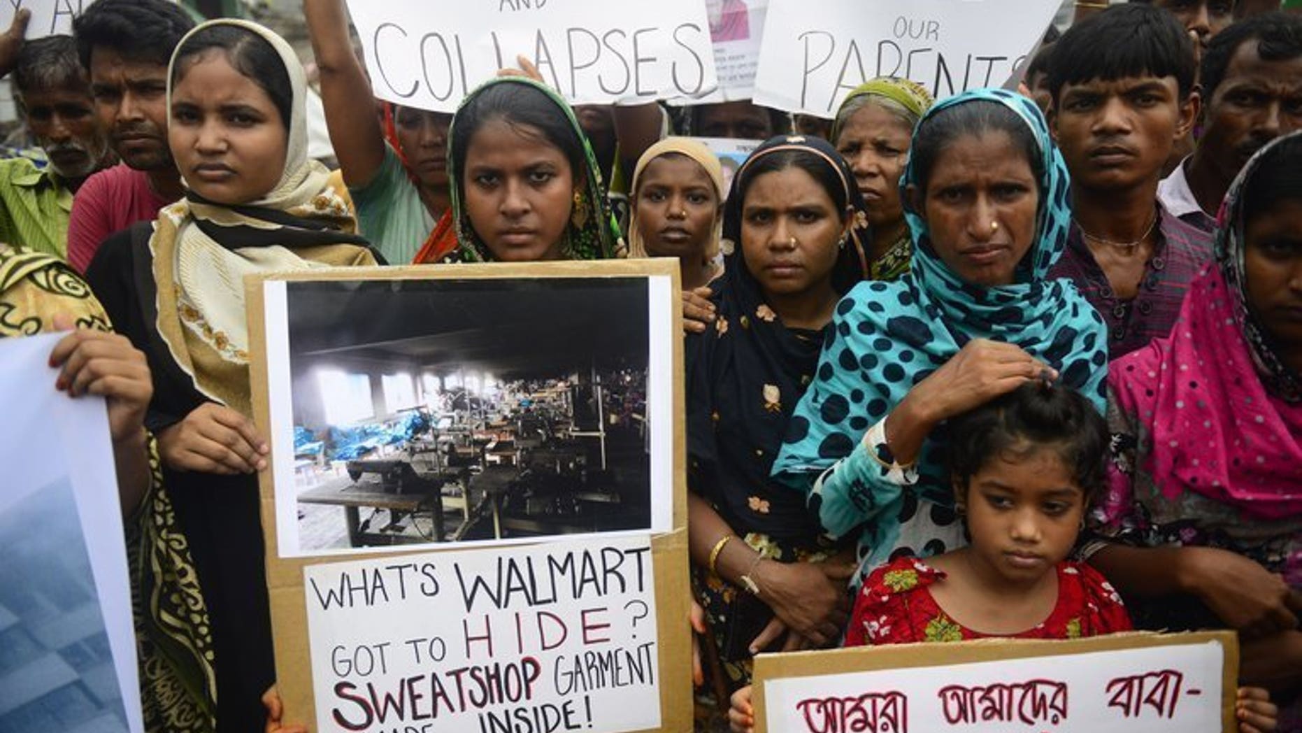 Relatives of Bangladeshi workers who lost their lives in a garment factory disaster protest in Savar, on June 29, 2013. Bangladesh Monday approved a new labour law to strengthen employees' rights and improve workplace safety, following a factory building collapse that killed 1,129 people.