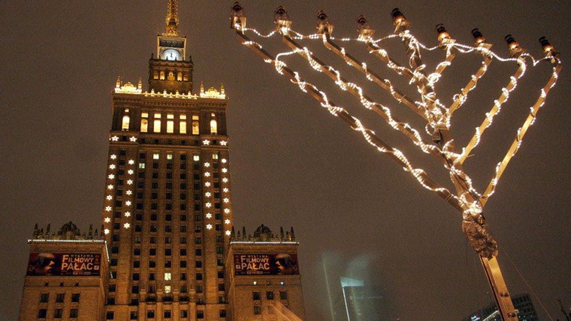 FILE -- December 28, 2005: A giant menorah is decorated with lights in front of the Palace of Culture in Warsaw's downtown during a ceremony for Hanukkah.