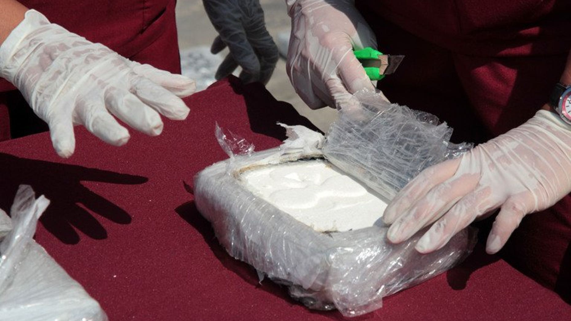 Criminology specialists test cocaine seized in Maracaibo, Zulia state, Venezuela, on April 25, 2013. Spanish police said Monday they had arrested a notorious British drug dealer, Brian Charrington, whom they accused of running an international trafficking racket involving cocaine from Venezuela.