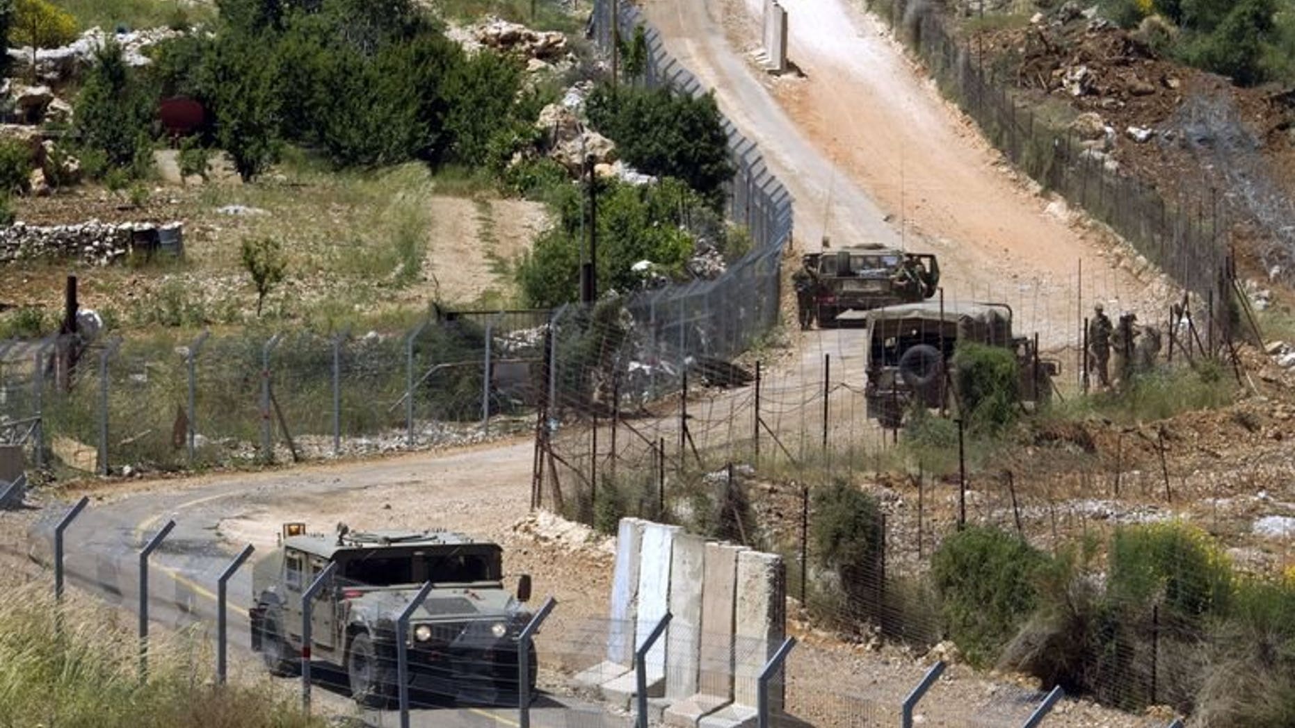 Israeli soldiers patrol the border fence between the Golan Heights and Syria next to the Druze village of Majdal Shams, on June 3, 2011. The Israeli military has confirmed that mortar fire from inside war-torn Syria landed in the Golan Heights.