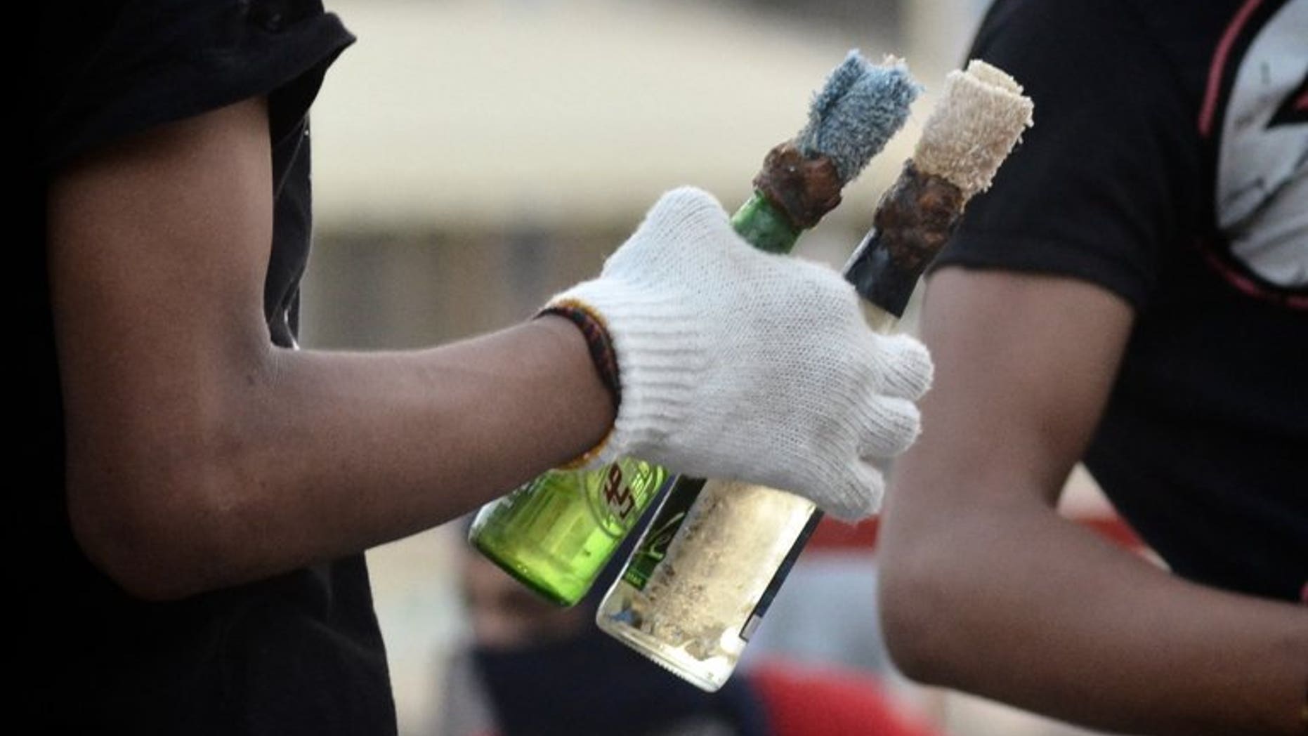 A Bahraini protester holds Molotov cocktails during clashes with riot police in Sitra, on June 7, 2012. Bahraini authorities have arrested three "terrorists" who allegedly hurled firebombs at the home of a Shiite lawmaker without causing casualties even though he was inside when the assault occurred.