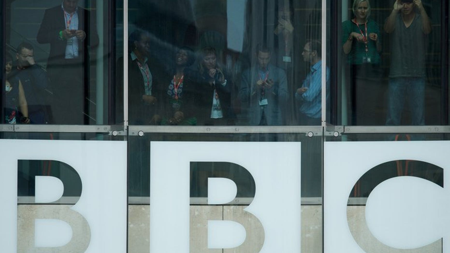 Members of the BBC staff are seen in the of Broadcasting House in central London on June 7, 2013. The BBC has spent around ??5 million on inquiries related to the Jimmy Savile scandal, the broadcaster revealed in its annual report.