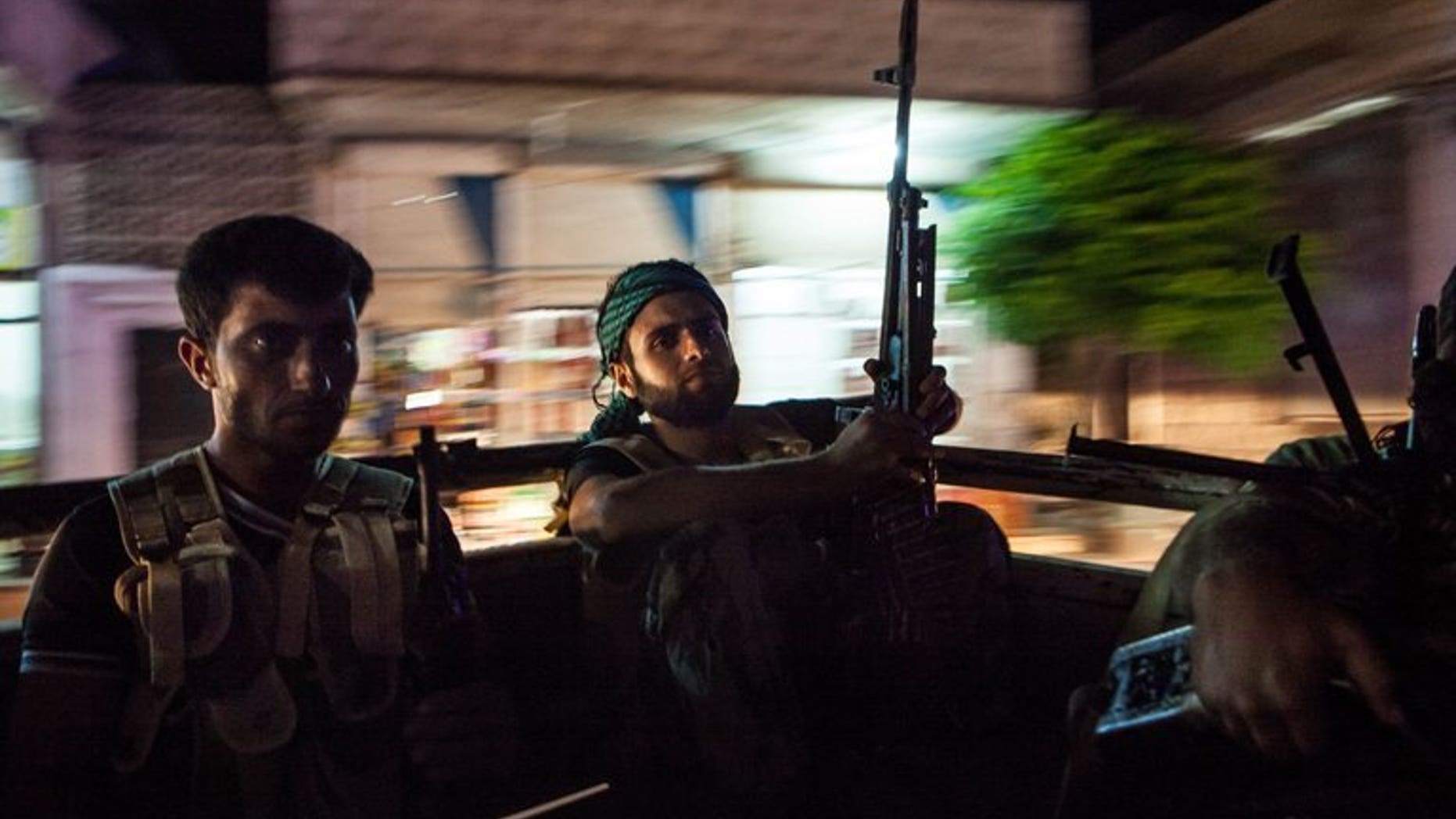 Syrian rebels head to the town of Bsankol in the northwestern province of Idlib on July 11, 2013. Britain is to give Syrian opposition fighters equipment to protect them against chemical weapons attacks "as a matter of special urgency", Foreign Secretary William Hague said.