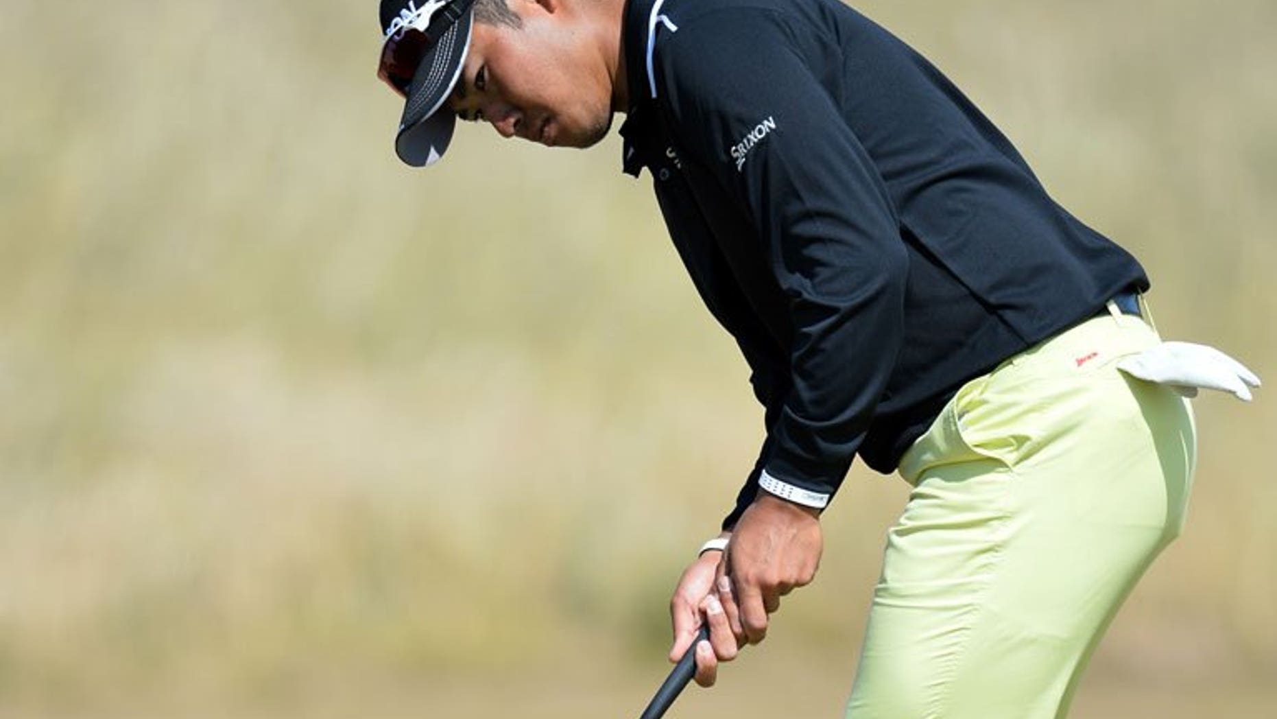 Japan's Hideki Matsuyama putts on the seventh green at Muirfield golf course in Scotland, on July 15, 2013. Matsuyama has sought out the advice of veteran compatriot Shigeki Maruyama to help him prepare for his British Open debut at Muirfield this week.