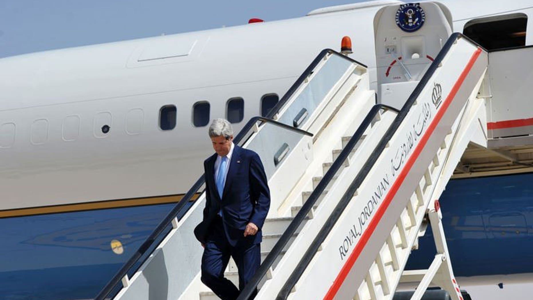 US Secretary of State John Kerry steps off his plane upon his arrival at Queen Alia International Airport in Amman, Jordan on July 16, 2013. Top US diplomat John Kerry met his Jordanian counterpart Tuesday for talks focused on the turmoil in Egypt and Syria as well as his bid to unlock the Middle East peace process.