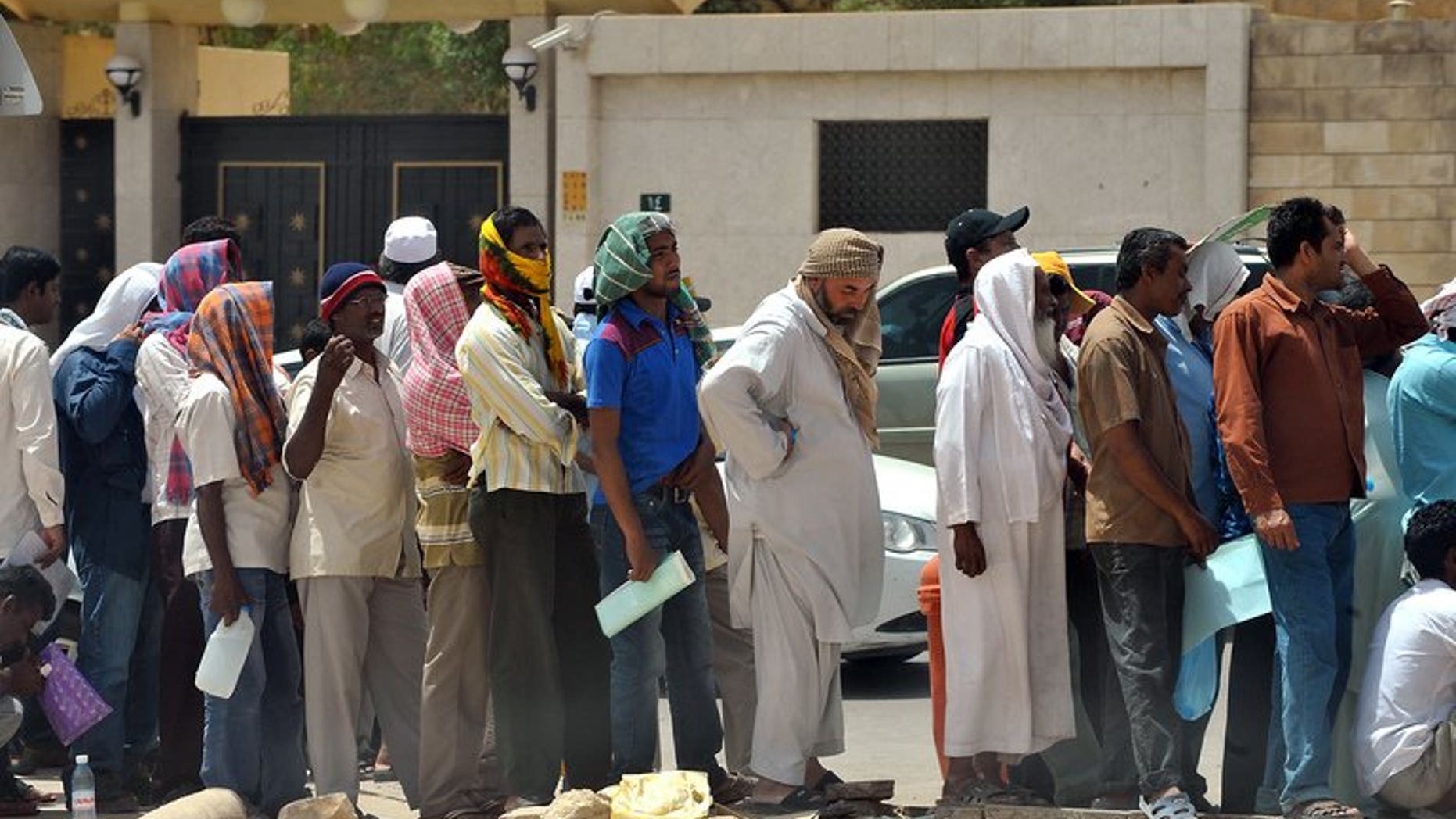 Foreign unauthorized laborers queue outside the Saudi immigration offices in the Al-Khazan district, west of Riyadh, on May 28, 2013. Saudi Arabia announced on Tuesday new rules to protect the rights of foreign domestic workers, most of whom are from South Asia, but stressed they must "respect" Islam and "obey" their employers.