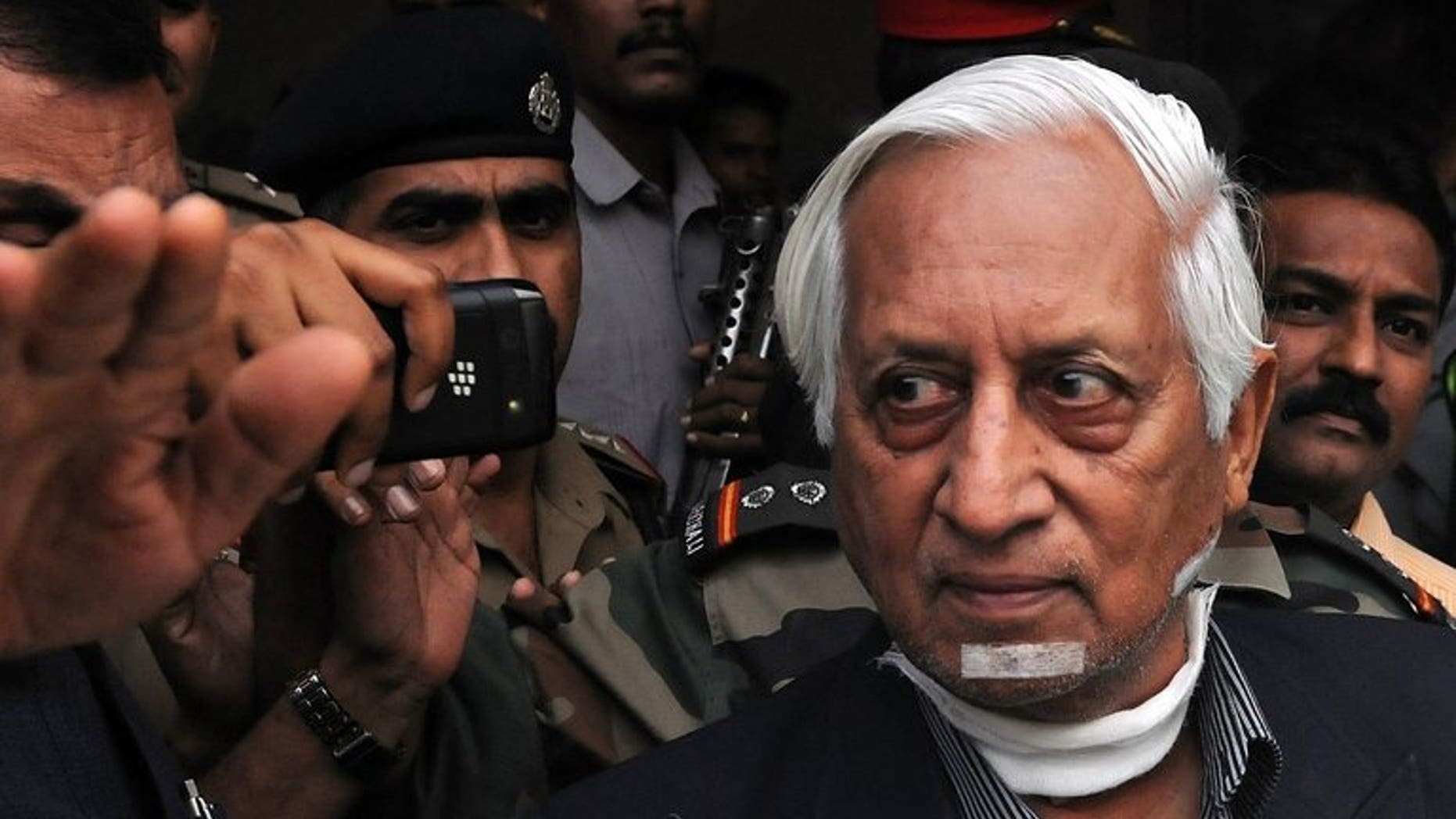 Retired Indian lieutenant general Kuldip Singh Brar (R) is escorted out of the Chattrapati Shivaji International Airport after his arrival from London in Mumbai on October 3, 2012. Brar, the Indian general who commanded the 1984 Amritsar Golden Temple assault, had his throat slashed in a deliberate revenge attack by a Sikh gang, a London court heard Tuesday.