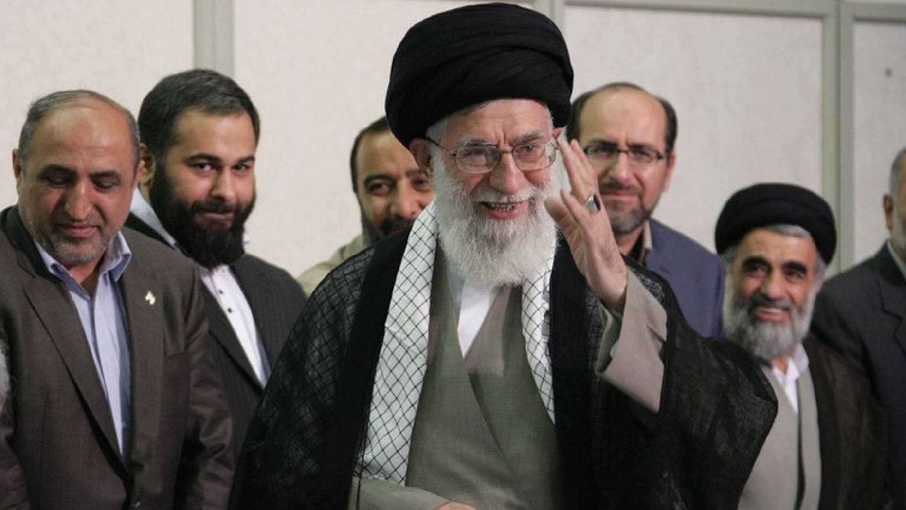 A handout picture released by the official website of the Iranian supreme leader Ayatollah Ali Khamenei shows him (C) smiling in Tehran on June 14, 2013. Khamenei on Tuesday appointed four clerics to Iran's powerful Guardians Council, a body dominated by ultra-conservatives that interprets the constitution and supervises elections, media reported.