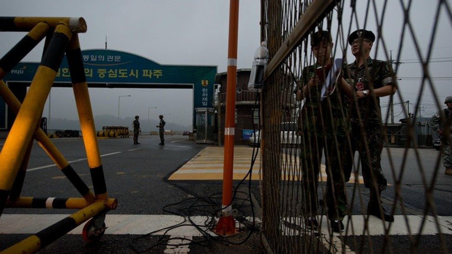 South Korean soldiers stand at a military checkpoint leading to North Korea's Kaesong joint industrial complex, in the border city of Paju early on July 10, 2013. North and South Korea will hold fresh talks Wednesday on reopening their joint industrial zone as hopes of an early agreement fade following months of friction.