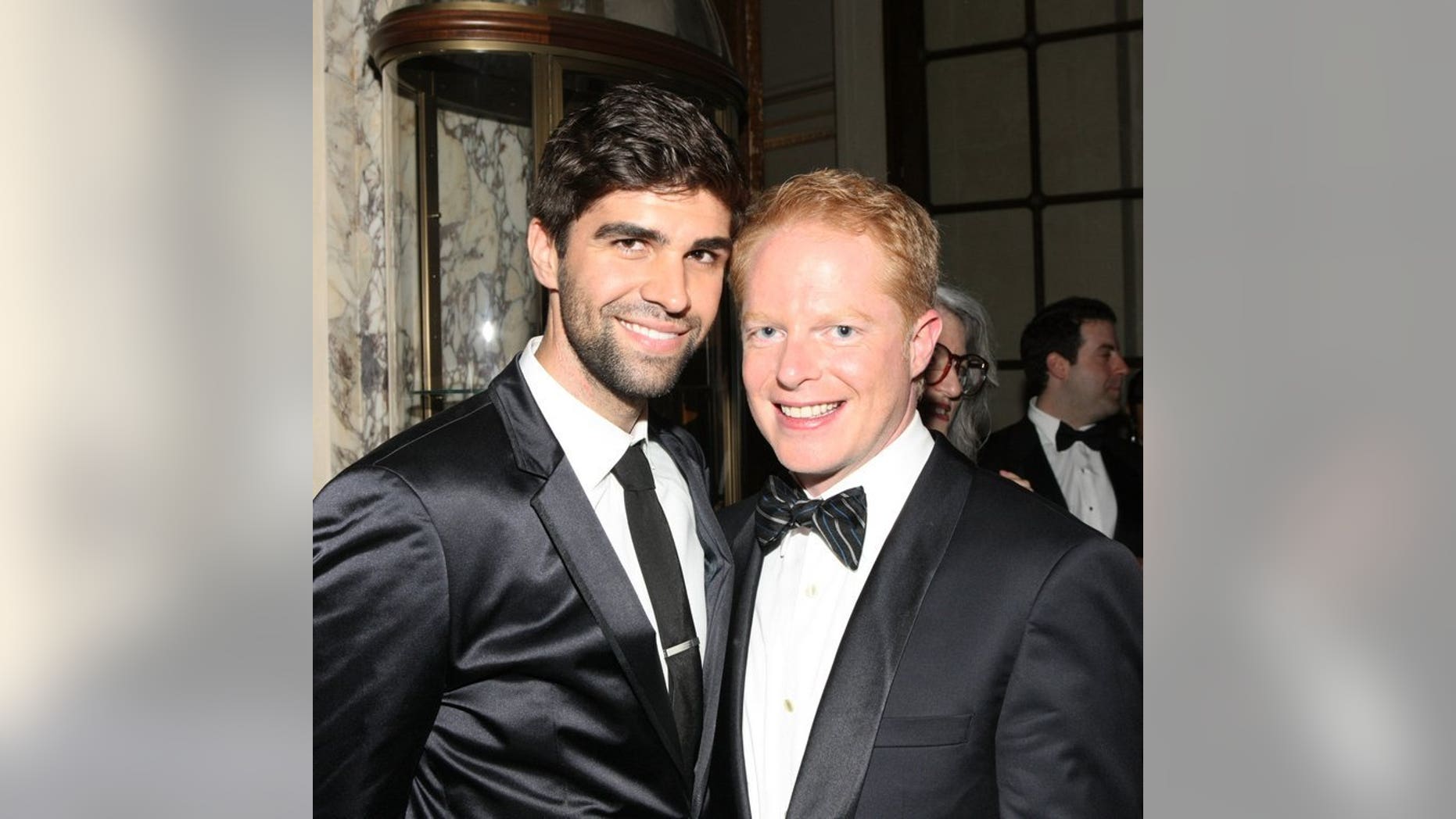 Actor Jesse Tyler Ferguson (R) and his partner Justin Mikita attend the Tony Awards on June 9, 2013 in New York. The pair will attend New Zealand's first same-sex marriage, set to take place on a plane at 30,000 feet (9,150 metres).