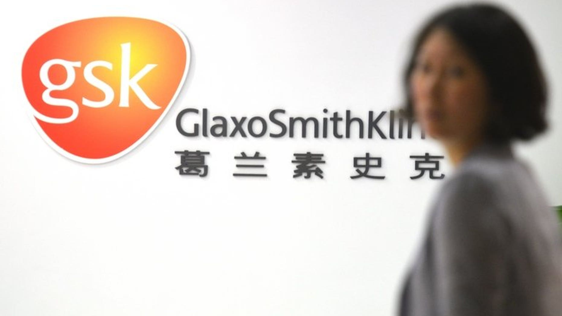 An employee of British drug firm GlaxoSmithKline (GSK) enters their office headquarters in Shanghai on July 1, 2013. A Chinese state newspaper on Wednesday called GlaxoSmithKline, which is under investigation for bribery in China, "dirty and devious", accusing the firm of inflating its prices.
