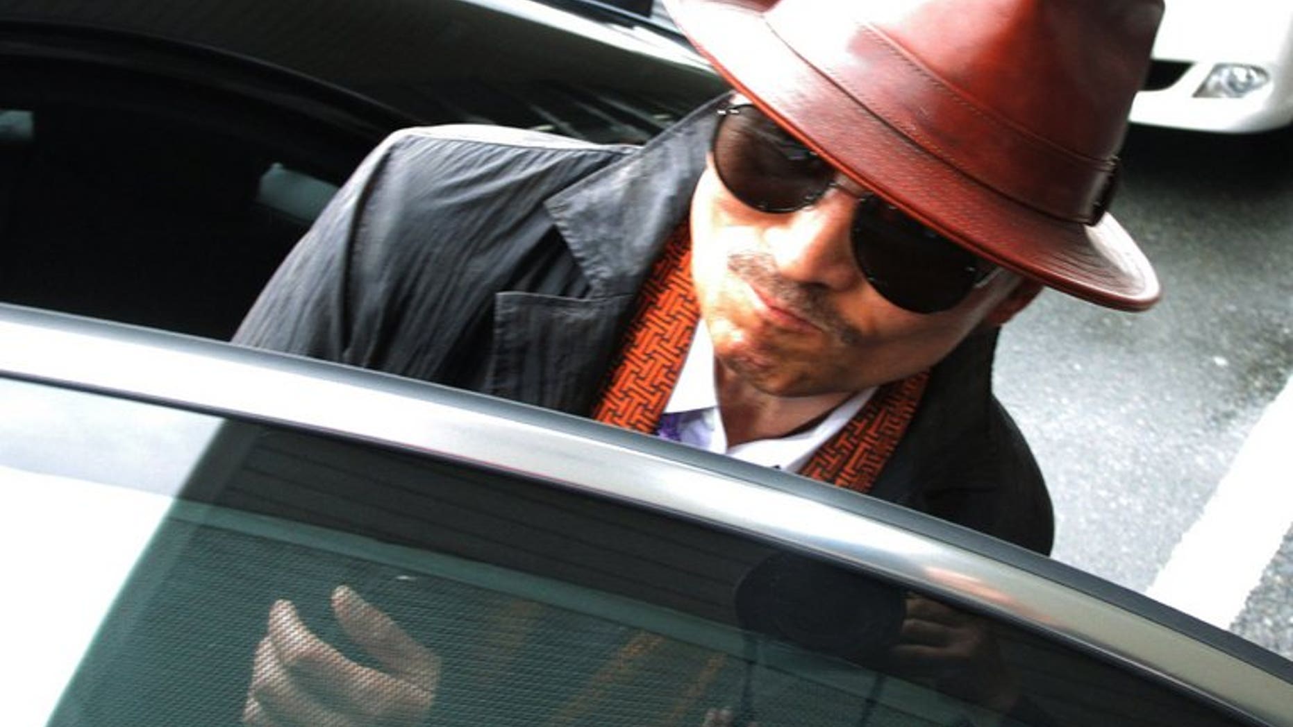 Kenichi Shinoda, the boss of Japan's largest "yakuza" gang, the Yamaguchi-gumi, gets into a car in Kobe, on April 9, 2011. A woman is suing Shinoda, seeking a refund of protection money paid to gangsters threatening to torch her bar, reports say
