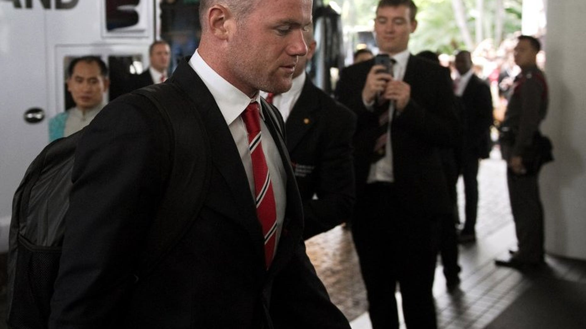Manchester United's Wayne Rooney arrives at the hotel in Bangkok, on July 11, 2013. United have rejected a bid from English Premier League rivals Chelsea for Rooney, according to British media reports.