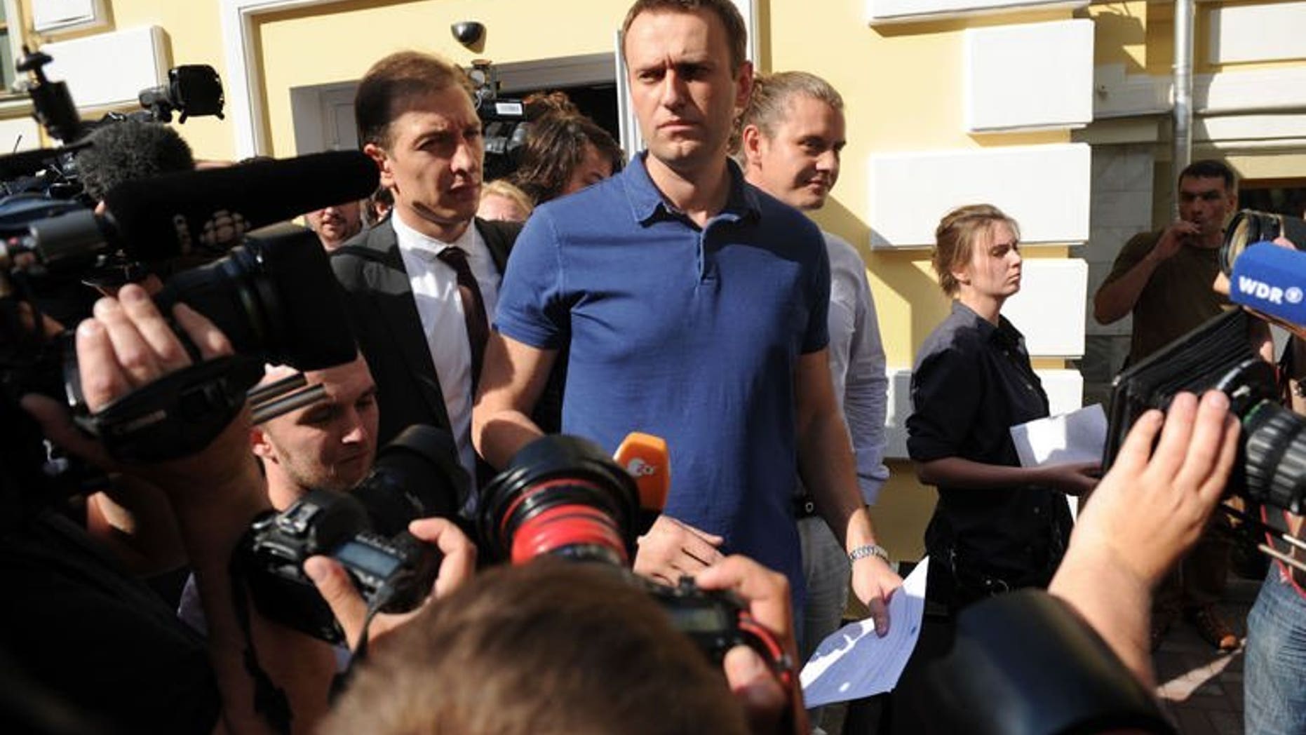 Russia's top opposition figure Alexei Navalny addresses journalists and supporters after visiting the city's election commission office to submit documents to get registered as a mayoral election candidate in Moscow July 10, 2013. Moscow authorities on Wednesday accepted Navalny's candidacy to run in mayoral polls, a day before a verdict is due in his trial on fraud charges.