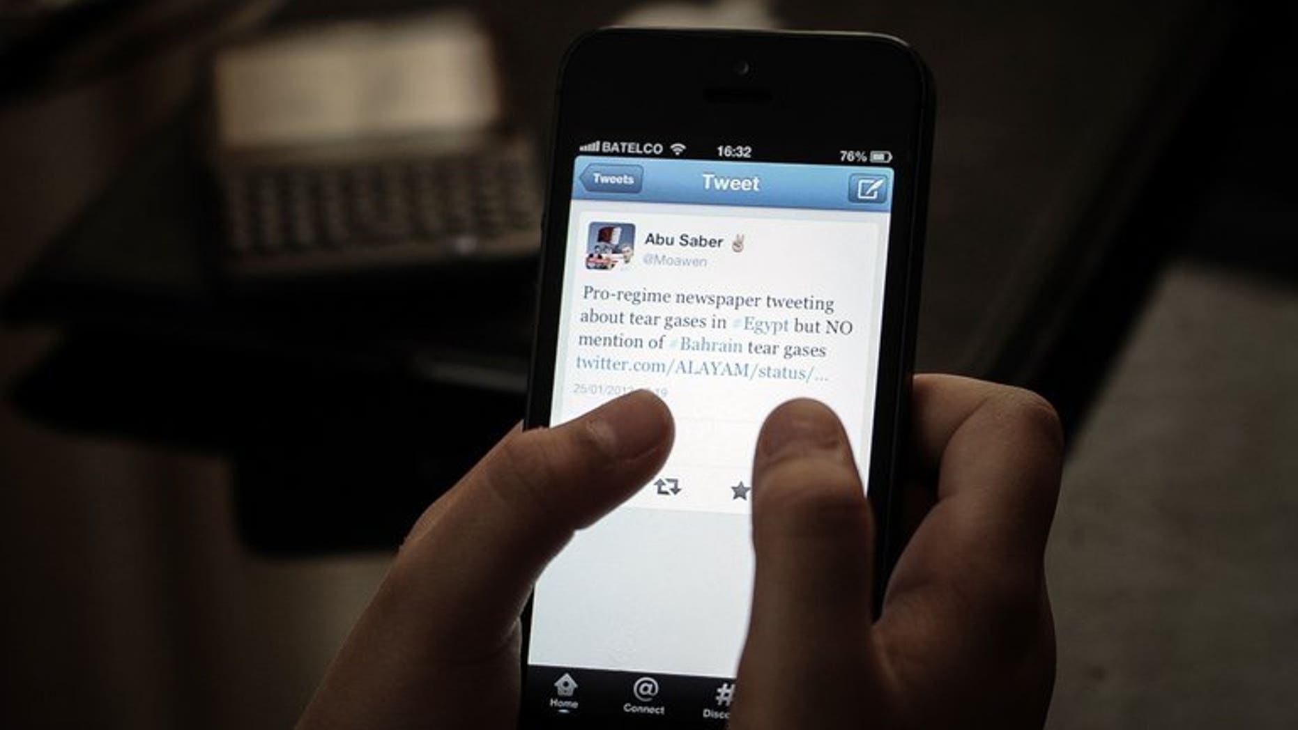 File picture shows a woman browsing Twitter on her smartphone in a coffee shop in the Bahraini capital Manama on January 29, 2013. Kuwait's appeals court on Wednesday upheld a 20-month jail term against a female opposition activist for making remarks on social network Twitter that were deemed insulting to the Gulf state's ruler.