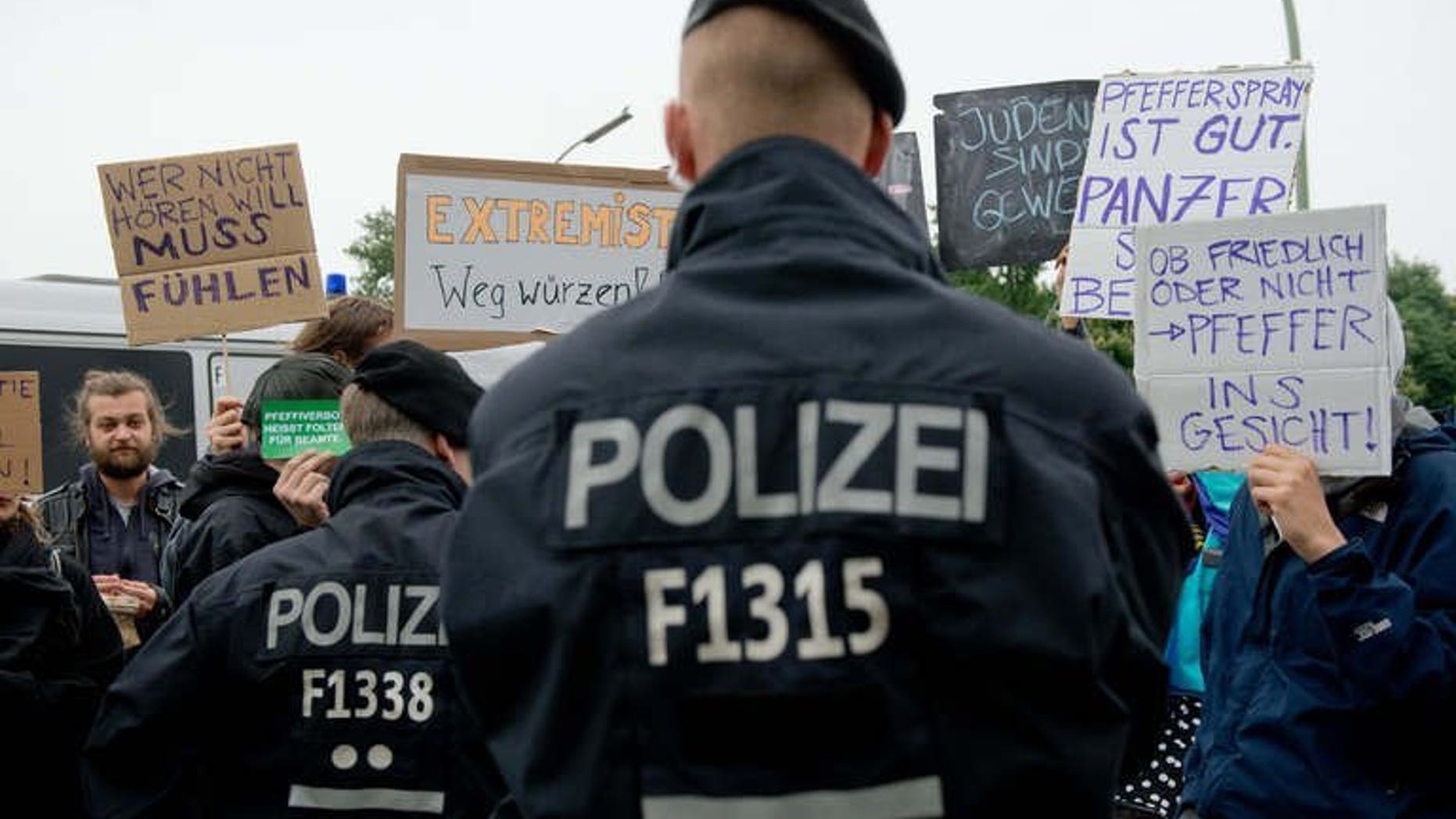 File picture shows police officers watching demonstraters stage a protest against the use of pepper spray in Berlin, Germany on May 25, 2013. Police launched raids in Germany, the Netherlands and Switzerland on Wednesday against six suspected members of a far-right "Werewolf" cell modelled on late-World War II plans for a Nazi guerrilla resistance.