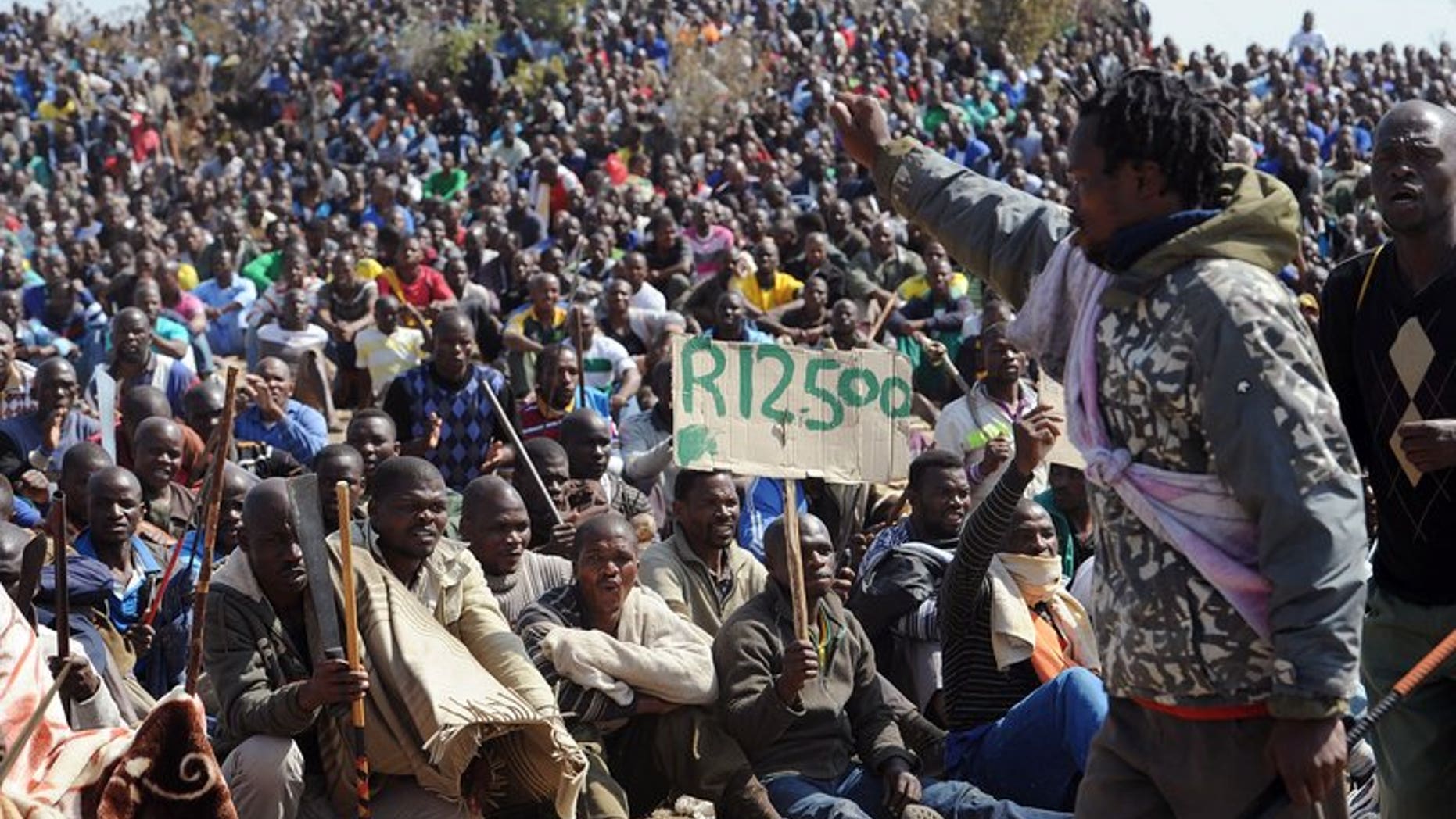 Miners sit together during a strike calling for increased wages, at a platinum mine in Marikana on August 16, 2012. Lawyers for relatives of 34 miners gunned down by South African police nearly a year ago said Wednesday they had pulled out of an already-troubled investigation into the deaths.
