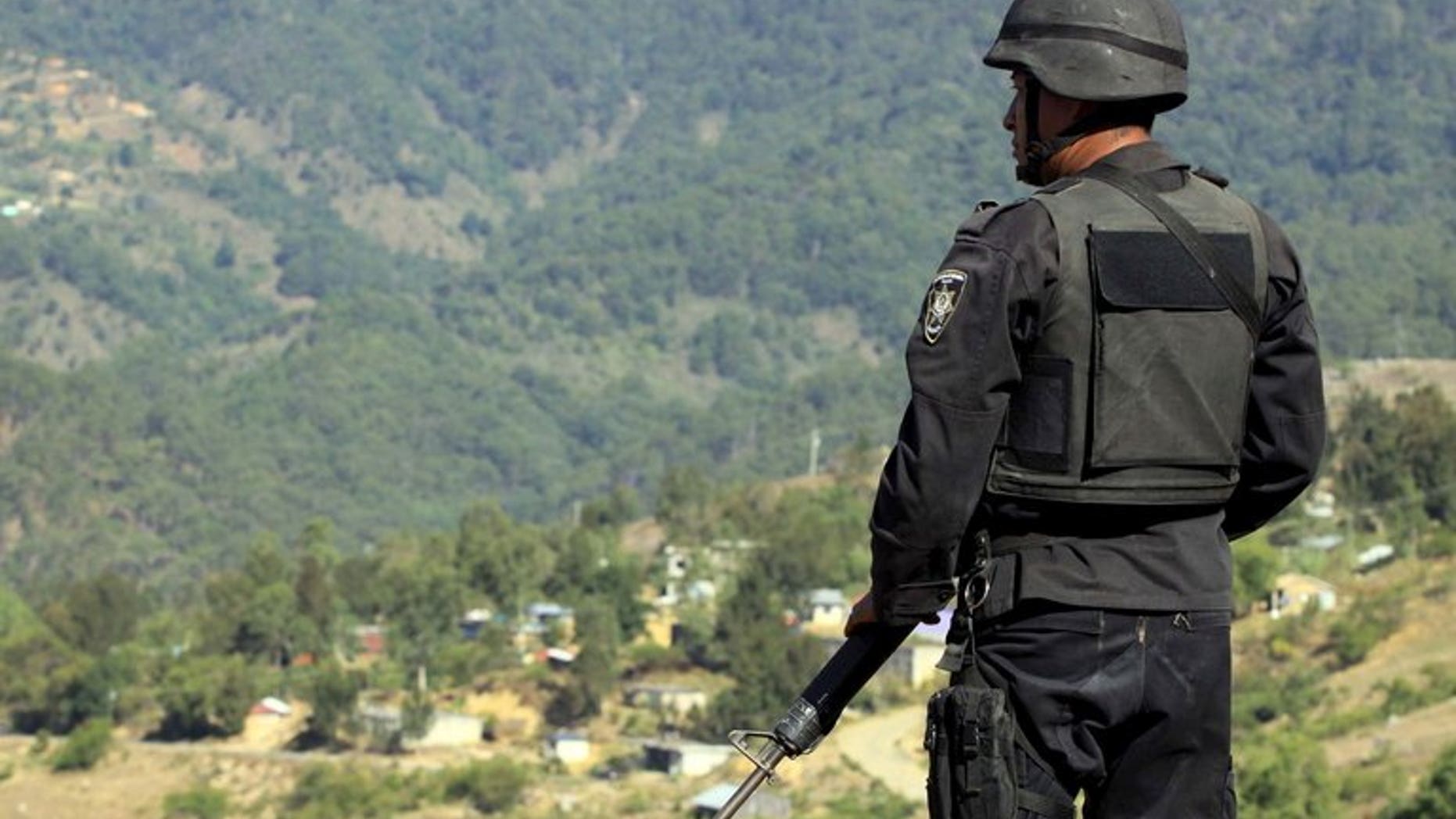 A Oaxaca State Police officer stands watch in Oaxaca, Mexico, on April 28, 2010. The bullet-riddled body of a Mexican crime beat reporter was found in the southern city of Oaxaca on Wednesday along with another unidentified victim, authorities said.