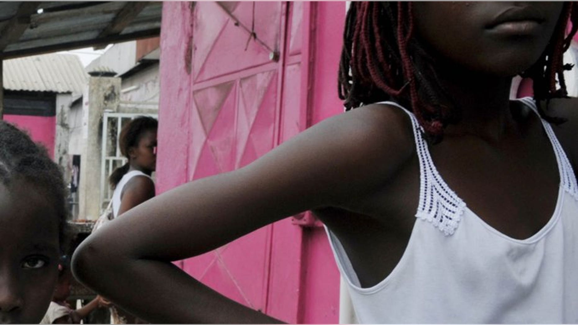 Gabonese youths stand outside a shop in Libreville on September 6, 2009. West African human trafficking is spawinging a Gabonese hell for some children.