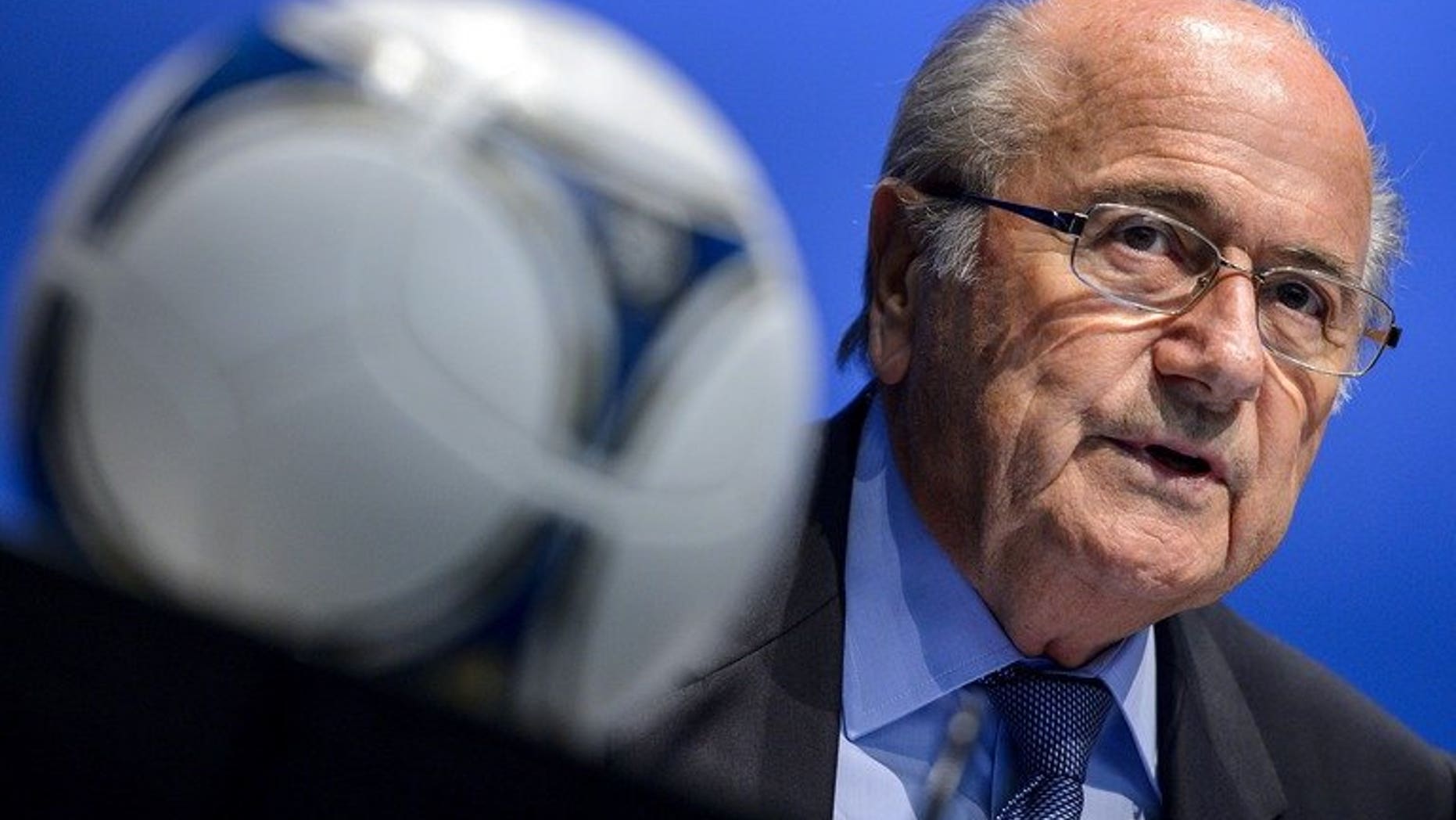 FIFA President Sepp Blatter looks on behind a football during a press conference on September 28, 2012 in Zurich. Blatter will push for the 2022 World Cup in Qatar to be moved to the winter after getting a personal taste of the Middle East's blast furnace climate.