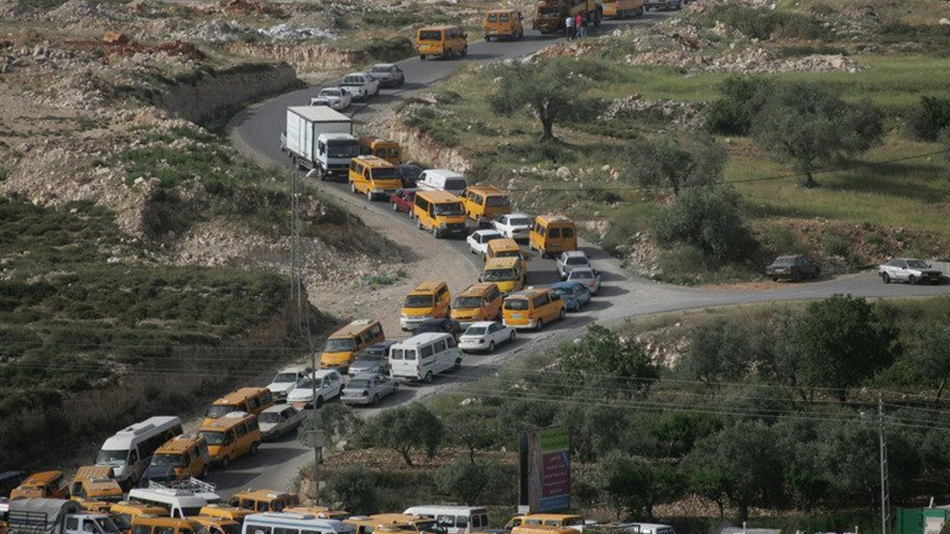 Palestinian vehicles are stuck in traffic on the main road linking the West Bank city of Ramallah with the nearby town of al-Bireh after Israeli troops forced hundreds of motorists to queue for ID checks on April 23, 2008. The Israeli military is preparing to lift some restrictions on Palestinian movement in advance of possible renewed peace talks, according to army radio.