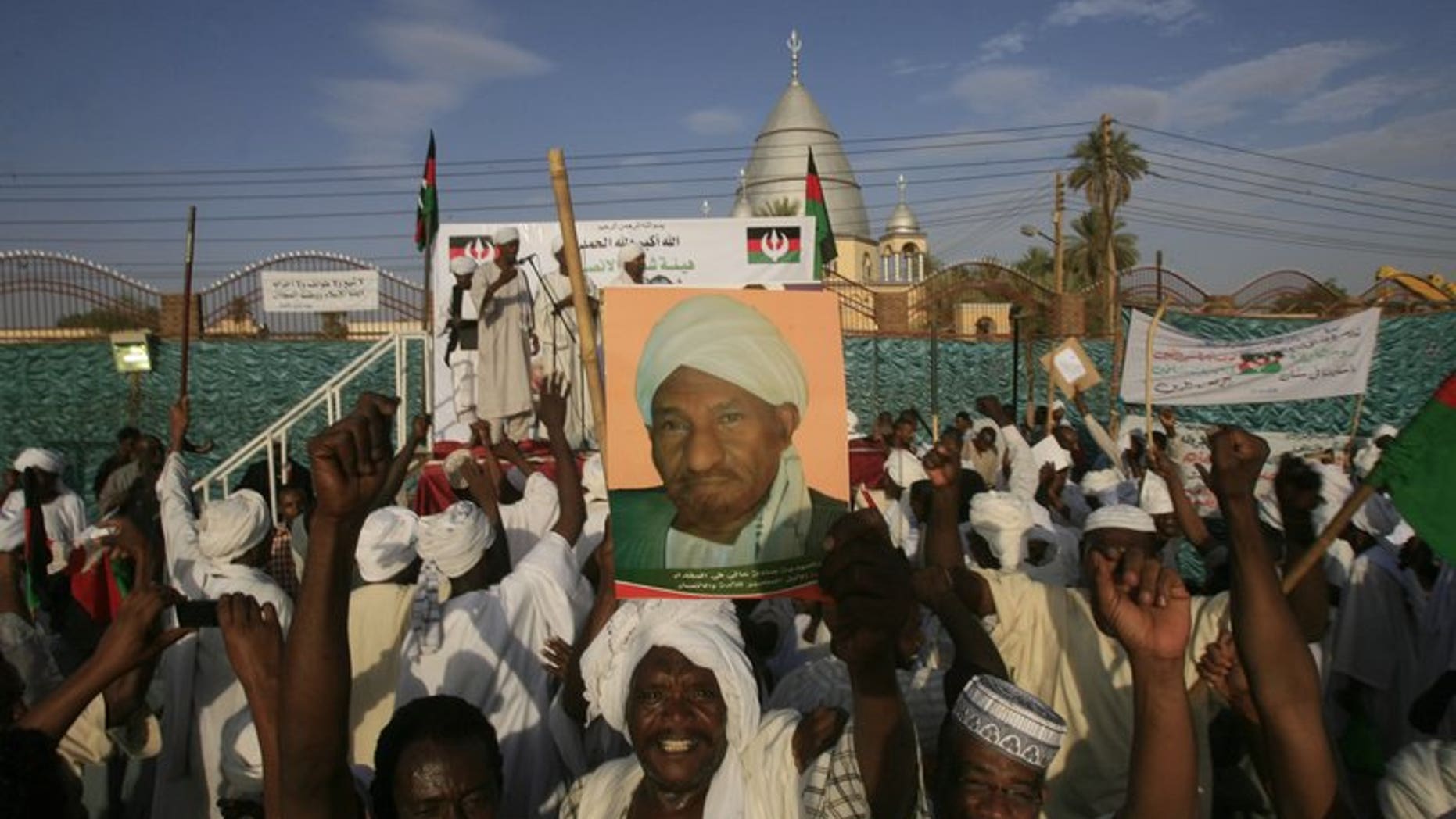 An Umma Party rally in Khalifa Square in Sudan???s twin capital of Omdurman last month. A reporter for the international news service Bloomberg has fled Sudan afraid for his safety after being threatened, assaulted and arbitrarily detained while covering an Umma Party meeting, a watchdog says.