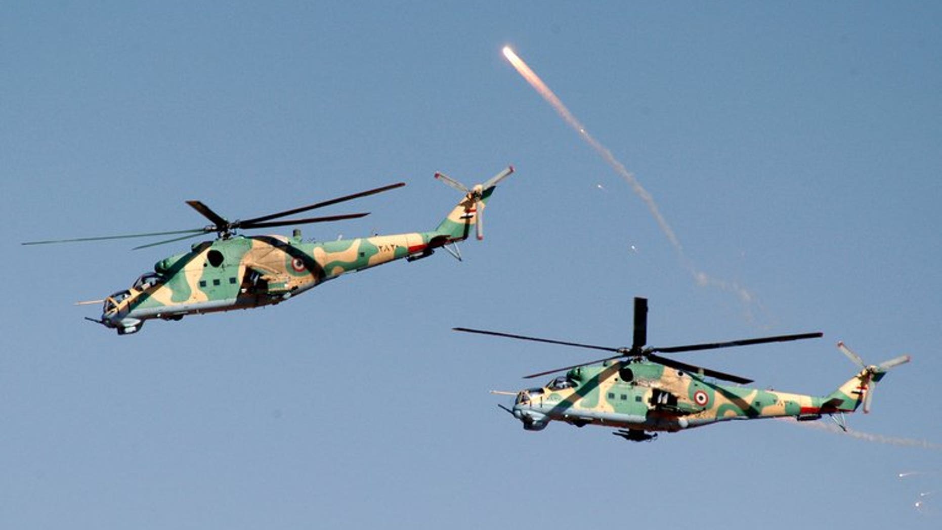 SYrian helicopters take part in military manoeuvres at an undisclosed location on December 20, 2011. A Syrian military helicopter fired rockets at a pro-rebel region of eastern Lebanon in the early hours of Thursday, a security source told AFP.