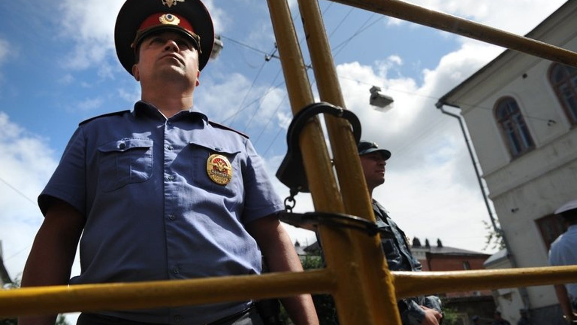 Police officers secure the courtyard of the tribunal in Kirov on July 18, 2013. British Foreign Secretary William Hague on Thursday warned against the "selective application of the rule of law" in Russia following the jailing of protest leader Alexei Navalny.
