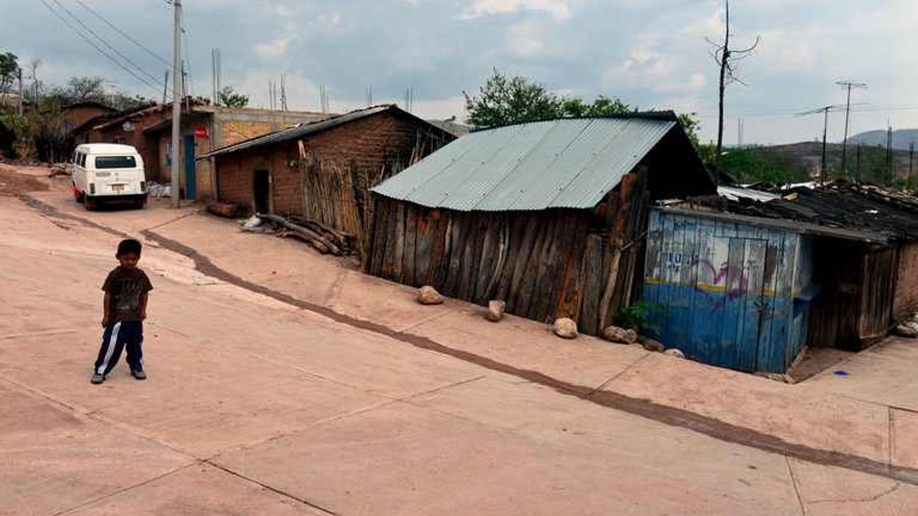 A child stands on a street of the Acatempa village, Chilpancingo, Guerrero state in Mexico on April 26, 2013. Some 1,000 people have fled their homes in southwestern Mexico after gunfights erupted in their villages and criminal groups threatened them, officials said Thursday.