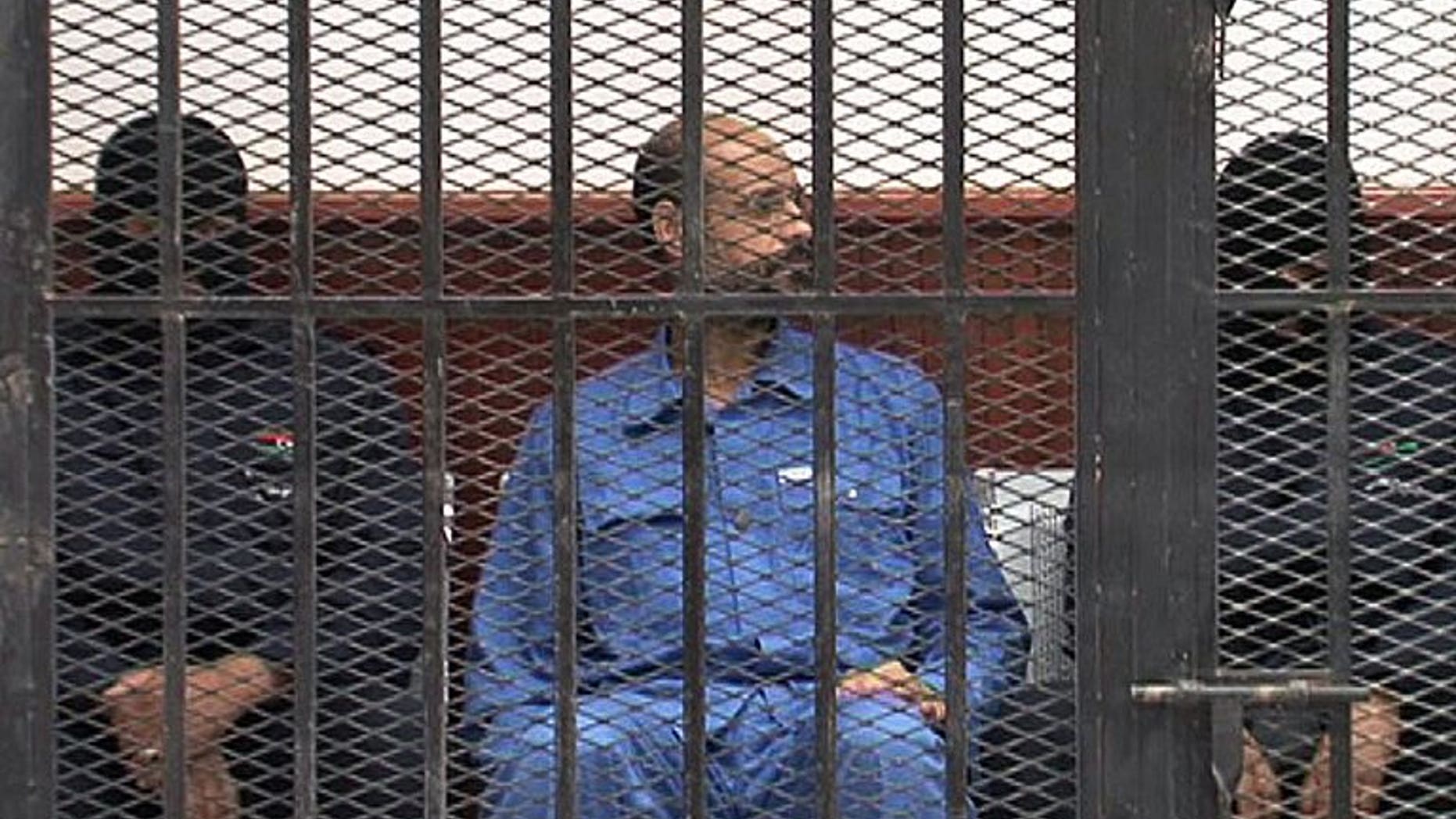 Seif al-Islam, son of Libya's late dictator Moamer Kadhafi, is pictured in the accused cell as he stands trial on May 2, 2013 in Libya's northwestern town of Zintan. The ICC on Thursday rejected Tripoli's request to suspend the handover of Seif al-Islam.