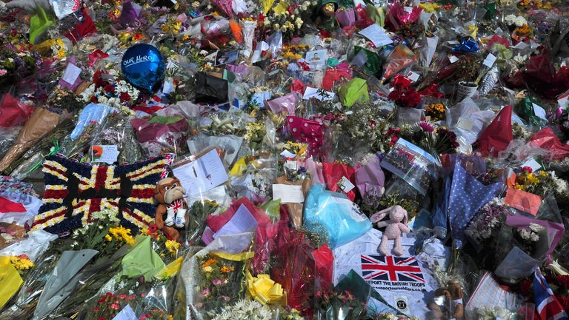 Floral tributes are seen at the scene of the murder of Lee Rigby outside Woolwich Barracks on May 31, 2013. Police are investigating claims that one of the two chief suspects in a brutal suspected Islamist attack, against a British soldier on a London street, was assaulted in prison.