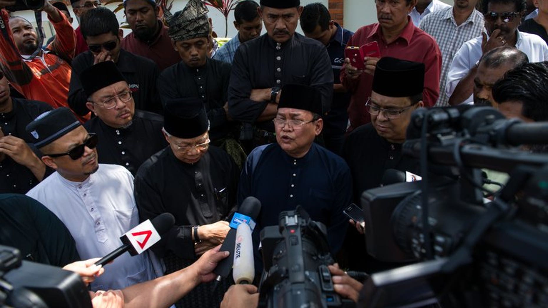 Members of the media surround protesters outside the Vatican embassy in Kuala Lumpur during a protest against the city-state's envoy to Malaysia on July 19, 2013. Several Islamic groups on Friday demanded the recall of the Vatican's first envoy to Malaysia, describing him as an "enemy of the state" after he supported the use of the word "Allah" by non-Muslims.