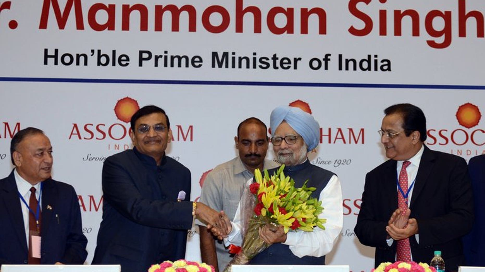 Manmohan Singh (centre right) at a meeting of industry leaders in New Delhi on Friday. India's Prime Minister urged investors to "remain optimistic", while acknowledging growth in 2013-14 is likely to fall short of the government's 6.5% target.
