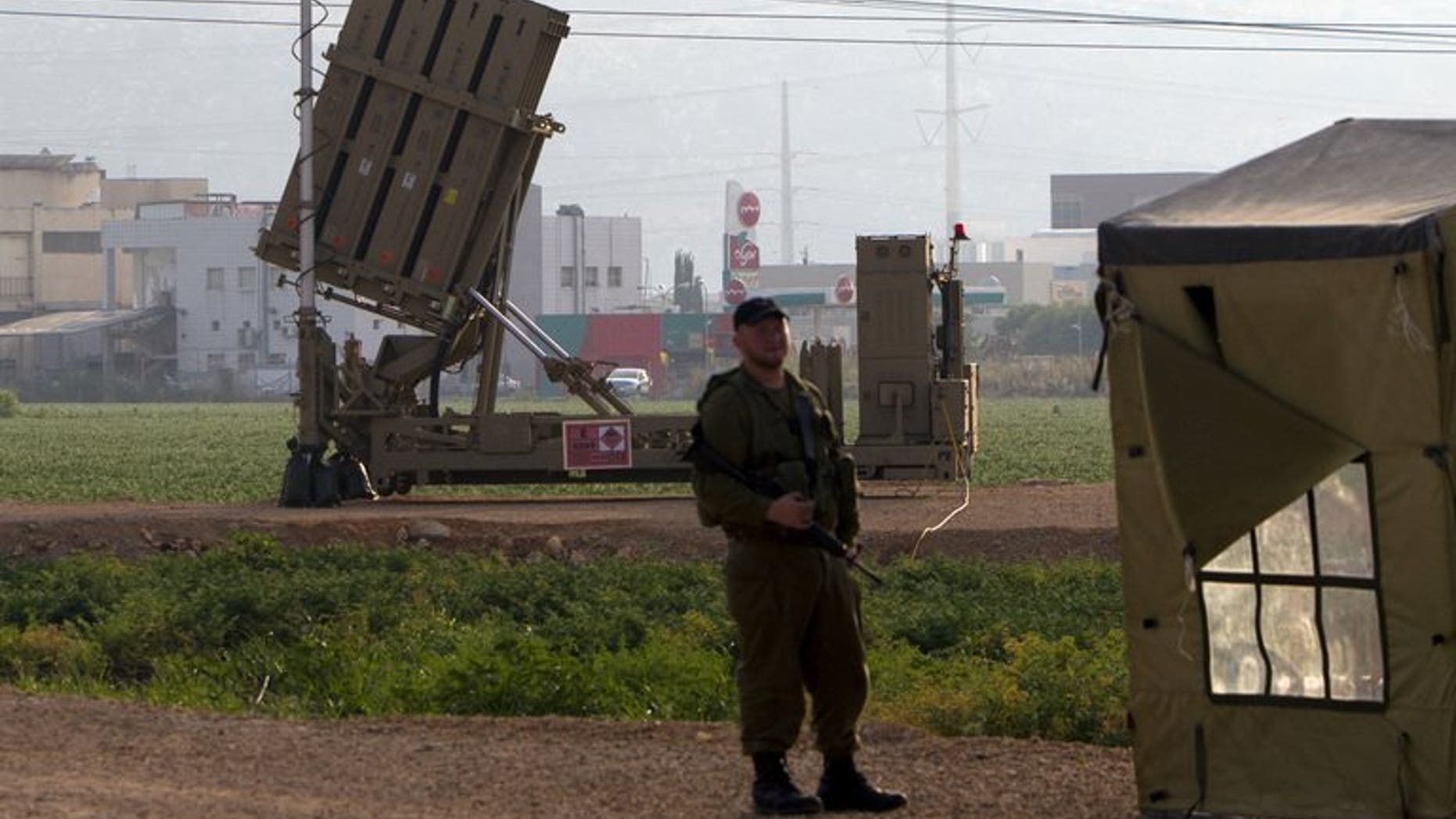 An Israeli soldier stands in front of an "Iron Dome" short-range missile defence system near the northern Israeli city of Haifa on May 6, 2013. Israel deployed its Iron Dome missile defence system near the Red Sea resort of Eilat, which is close to the border with Egypt, an army spokeswoman said.