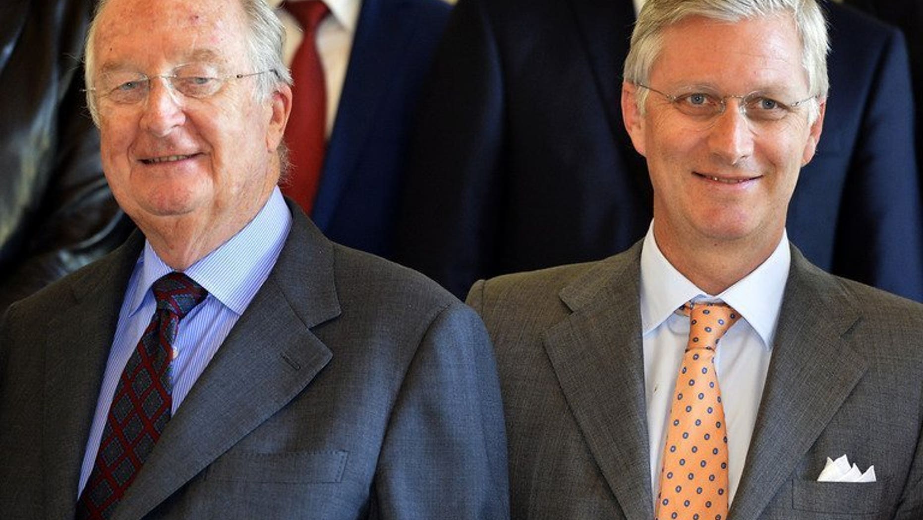 Belgium's King Albert II (R) and Crown Prince Philippe pose before a reception on July 8, 2013 at Laeken royal castle in Brussels. The easy-going style of the monarch, who abdicates Sunday in favour of his son Philippe, belies the power wielded by the sovereign in a country split by language, religion and history.
